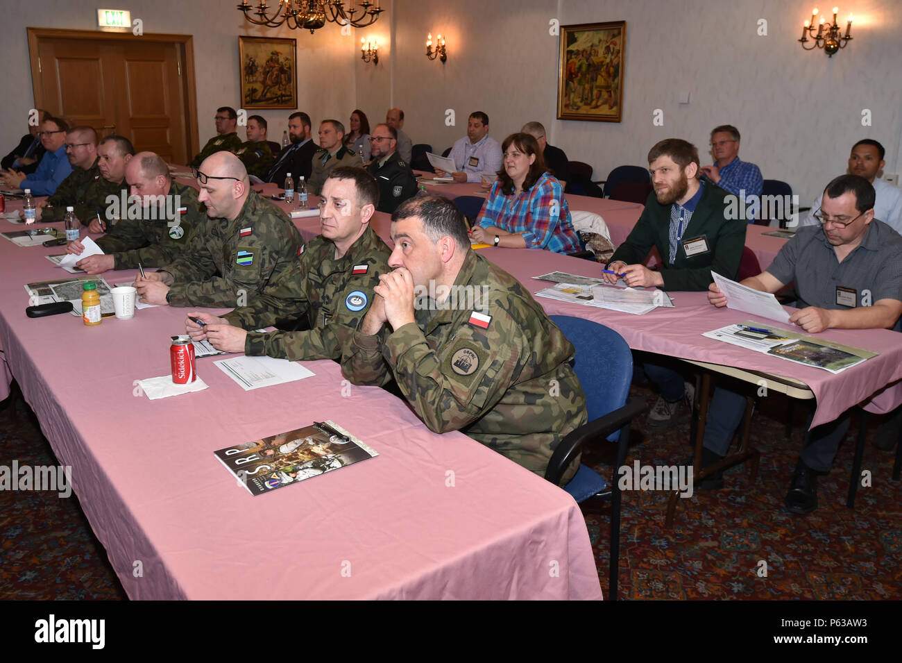 Attendees of the U.S. Army Europe’s Sustainable Range Program (SRP) Workshop 2016 listen to opening remarks at Tower Barracks, Grafenwoehr, Germany, April 18, 2016. This year’s SRP workshop theme is 'Enabling Readiness“. Training support personnel have the challenging mission to provide a training platform that guarantees realistic training conditions, while providing ambiguous training scenarios allowing a variety of opportunities to employ problem solving techniques. The development and use of military training facilities must integrate mission requirements with environmental requirements an Stock Photo