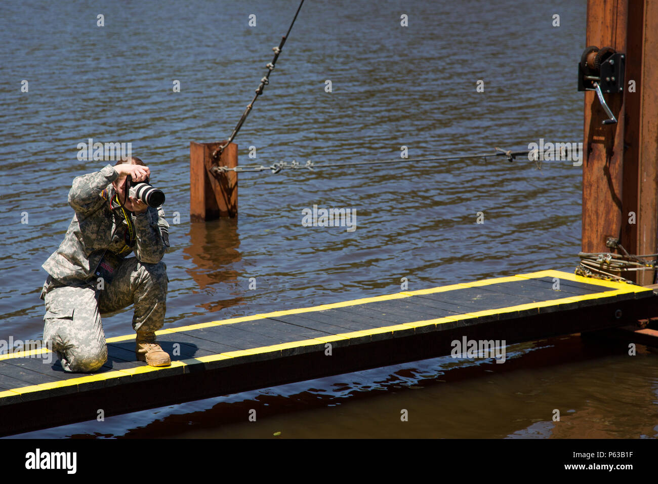 A U.S. Army photographer documents a Ranger moving across a rope to ...