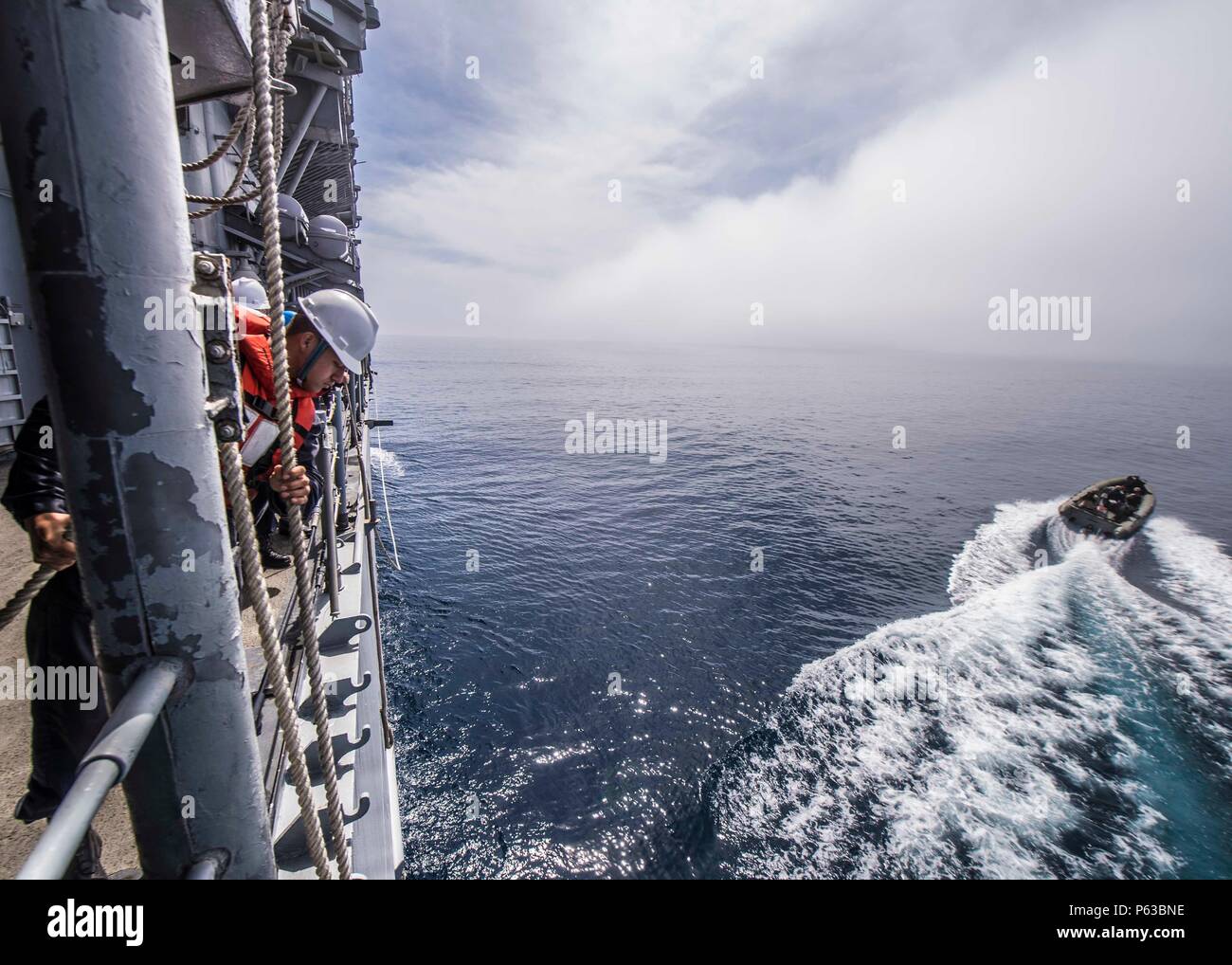 160405-N-FV739-061 PACIFIC OCEAN (April 5, 2016) Sailors lower a rigid ...