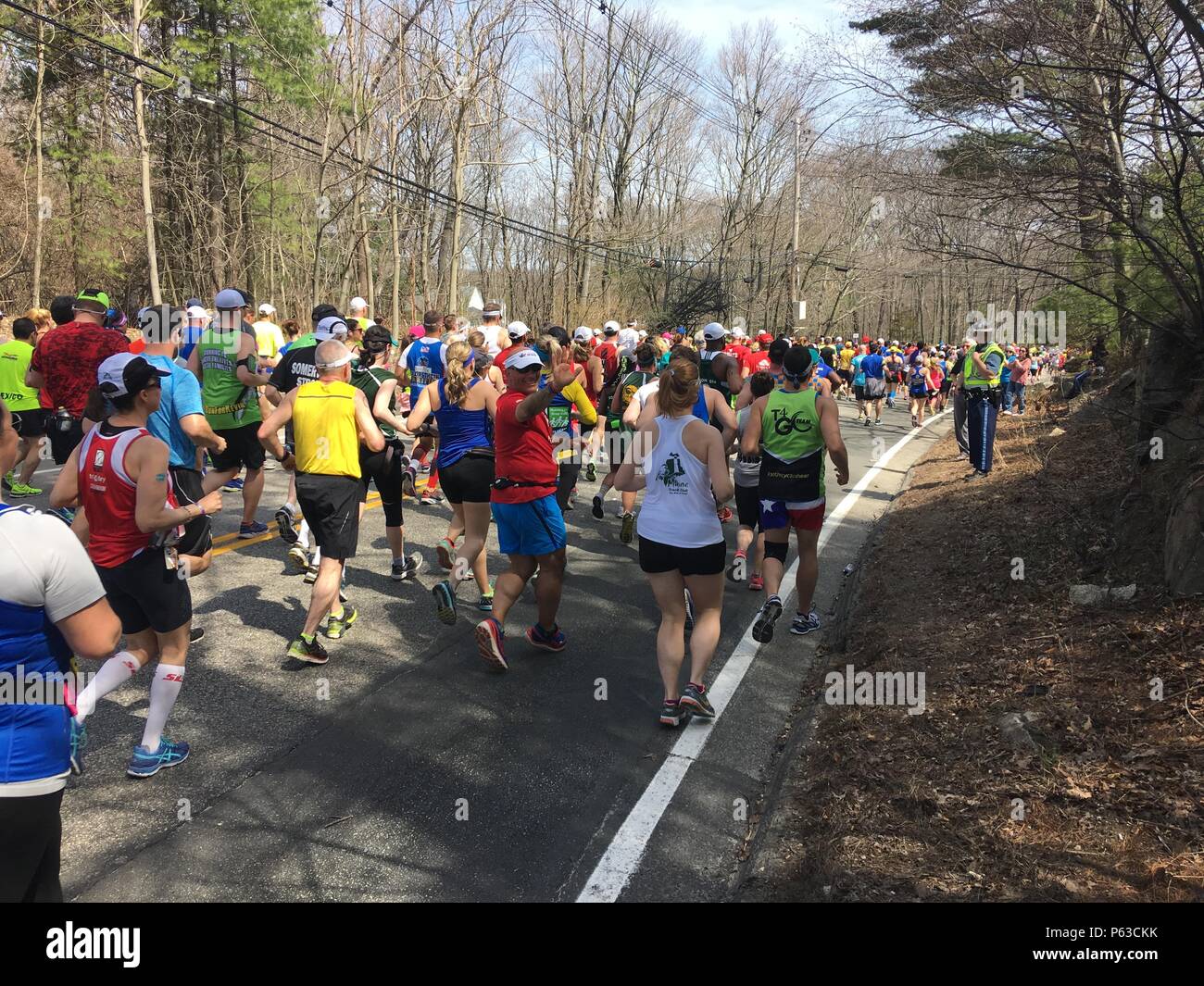 Senior Master Sgt. Tom Orifice and Senior Master Sgt. Scott Sanderson of the 104th Fighter Wing Logistics Readiness Squadron, run the Boston Marathon in support of Team Red, White, and Blue, April 18, 2016. The 104th Fighter Wing Security Forces serve and protect alongside the Massachusetts State Police and other law enforcement agencies in support of the 120th Boston Marathon, April 18, 2016. More than 500 Massachusetts Guardsmen ensured the route was safe for the over 30,000 runners who took part in the Boston Marathon.(U.S. Air National Guard photo by Master Sgt. Julie Avey) Stock Photo