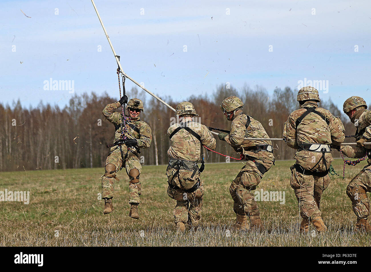 U.S. Army Soldiers assigned to Headquarters and Headquarters Troop, 3rd Squadron, 2nd Cavalry Regiment, pull a rope attached to a Latvian MI-17 helicopter as they land during special purpose insertion extraction training, Lielvarde Air Base, Latvia, April 21, 2016. Allies from Latvia, Canada, Lithuania and Germany participated in the event, which included cold and hot load training on UH-60 Blackhawk helicopters and fast rope insertion extraction exercises.  (U.S. Army photo by Sgt. Paige Behringer) Stock Photo