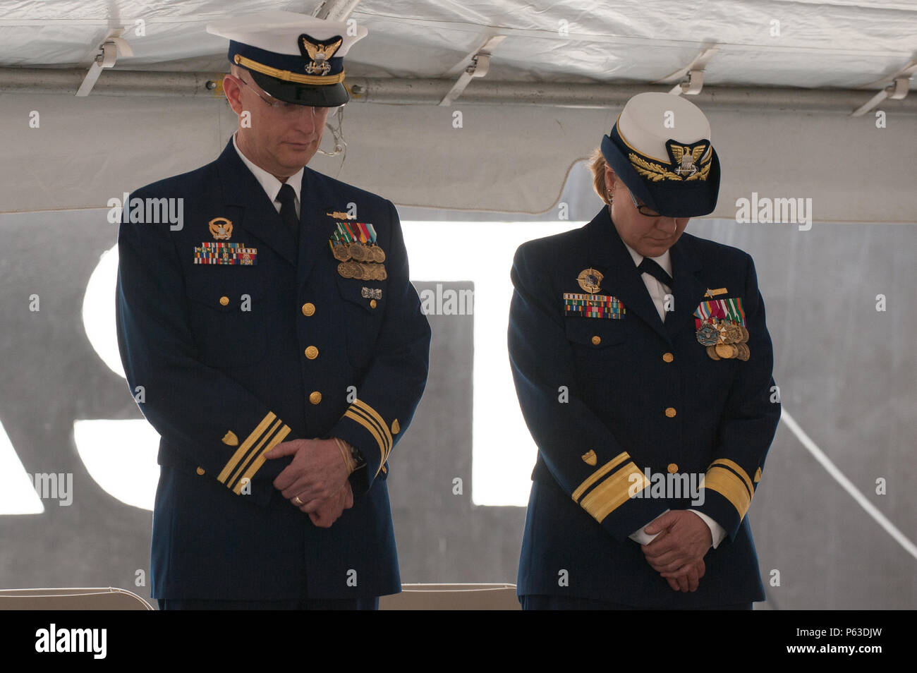 Lt. Cmdr. Daniel J. Twomey and Rear Adm. Linda Fagan bow their heads during  the change of command ceremony for the Coast Guard Cutter Willow, Friday,  April 22, 2016, in Newport, Rhode