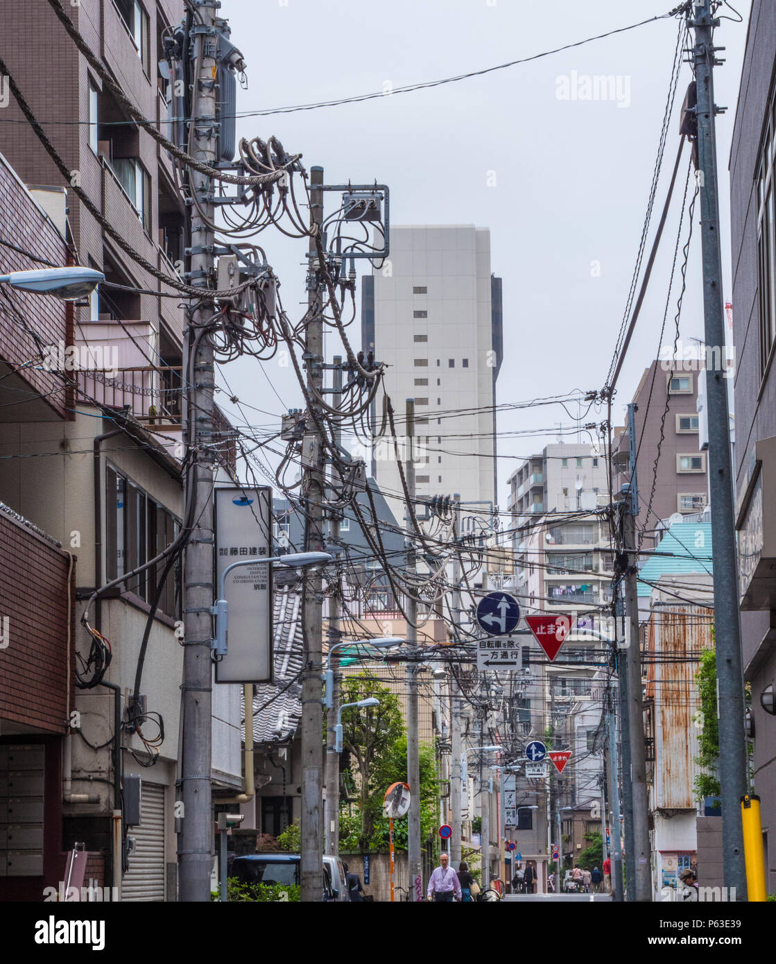 Street view in Tokyo full with electricity cables and connections
