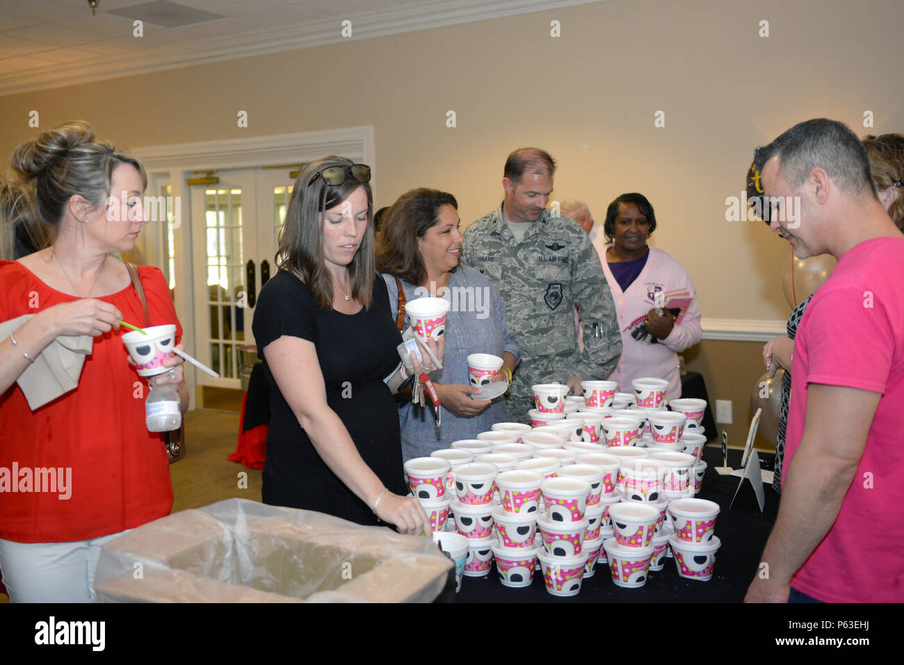 Attendees at the Volunteer Appreciation Event participate in an ice cream social after the ceremony, April 20, 2016, at Seymour Johnson Air Force Base, North Carolina. An array of desserts, including ice cream and cake, was provided to celebrate the hard work of volunteers. (U.S. Air Force photo by Airman 1st Class Ashley Williamson/Released) Stock Photo