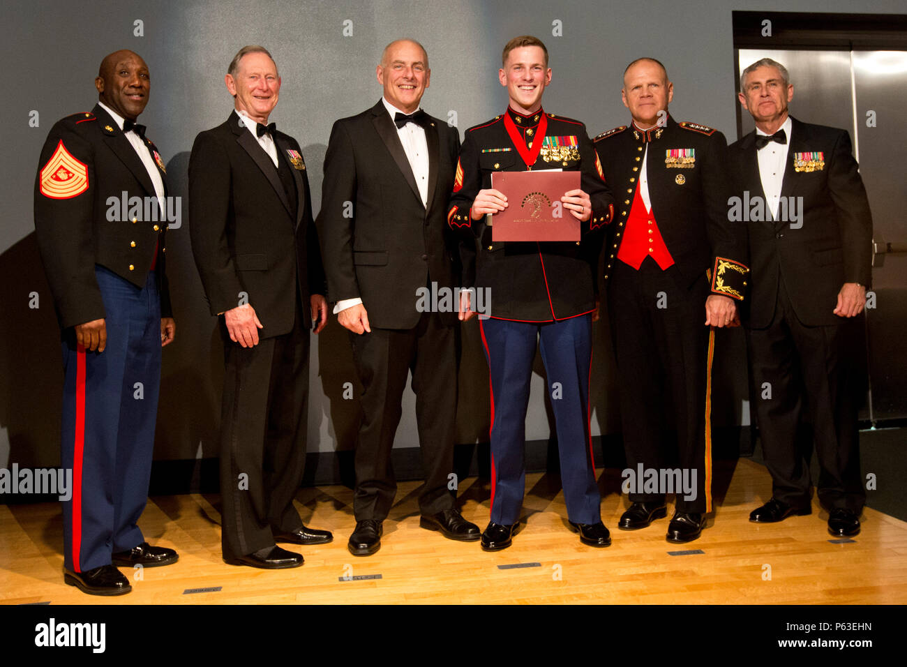 From left, Sgt. Maj. of the Marine Corps Ronald L. Green, retired U.S. Marine Gen. Walter E. Boomer, retired Marine Gen. John F. Kelly, Sgt. Reece Lodder, Commandant of the Marine Corps Gen. Robert B. Neller, and retired Marine Lt. Gen. Robert R. Blackman, Jr., pose for a group photo during the Marine Corps Heritage Foundation awards presentation at the National Museum of the Marine Corps, Triangle, Va., April 23, 2016. Lodder was the recipient of the Sergeant Major Dan Daly award for his photo album, 'Boot Camp Prep.' (U.S. Marine Corps photo by Staff Sgt. Gabriela Garcia/Released) Stock Photo