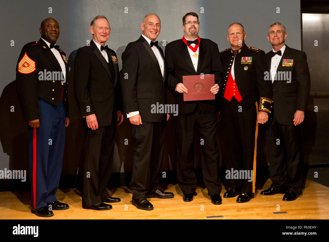 From left, Sgt. Maj. of the Marine Corps Ronald L. Green, retired U.S. Marine Gen. Walter E. Boomer, retired Marine Gen. John F. Kelly, Dr. David J. Ulbrich, Commandant of the Marine Corps Gen. Robert B. Neller, and retired Marine Lt. Gen. Robert R. Blackman, Jr., pose for a group photo during the Marine Corps Heritage Foundation awards presentation at the National Museum of the Marine Corps, Triangle, Va., April 23, 2016. Ulbrich was the recipient of the Colonel Robert D. Heinl, Jr. award for his submission, 'The U.S. Marine Corps, Amphibious Capabilities and Preparations for War with Japan.' Stock Photo