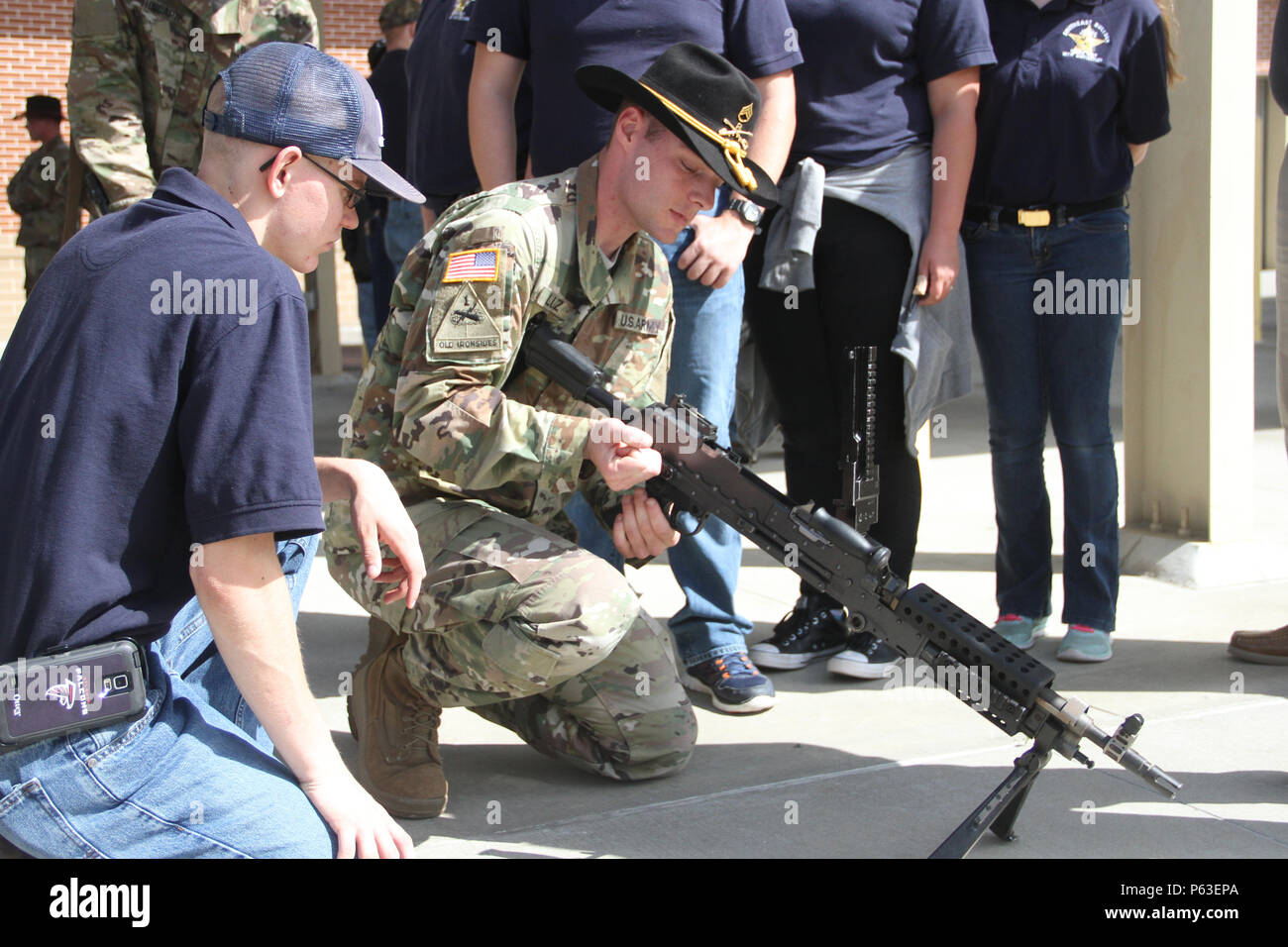 Staff Sgt. Robert Lutz, a senior section sergeant of 6th Squadron, 8th  Cavalry Regiment, 2nd Infantry Brigade Combat Team, 3rd Infantry Division,  shows Logan Gay, a sophomore from Southeast Bulloch High School,