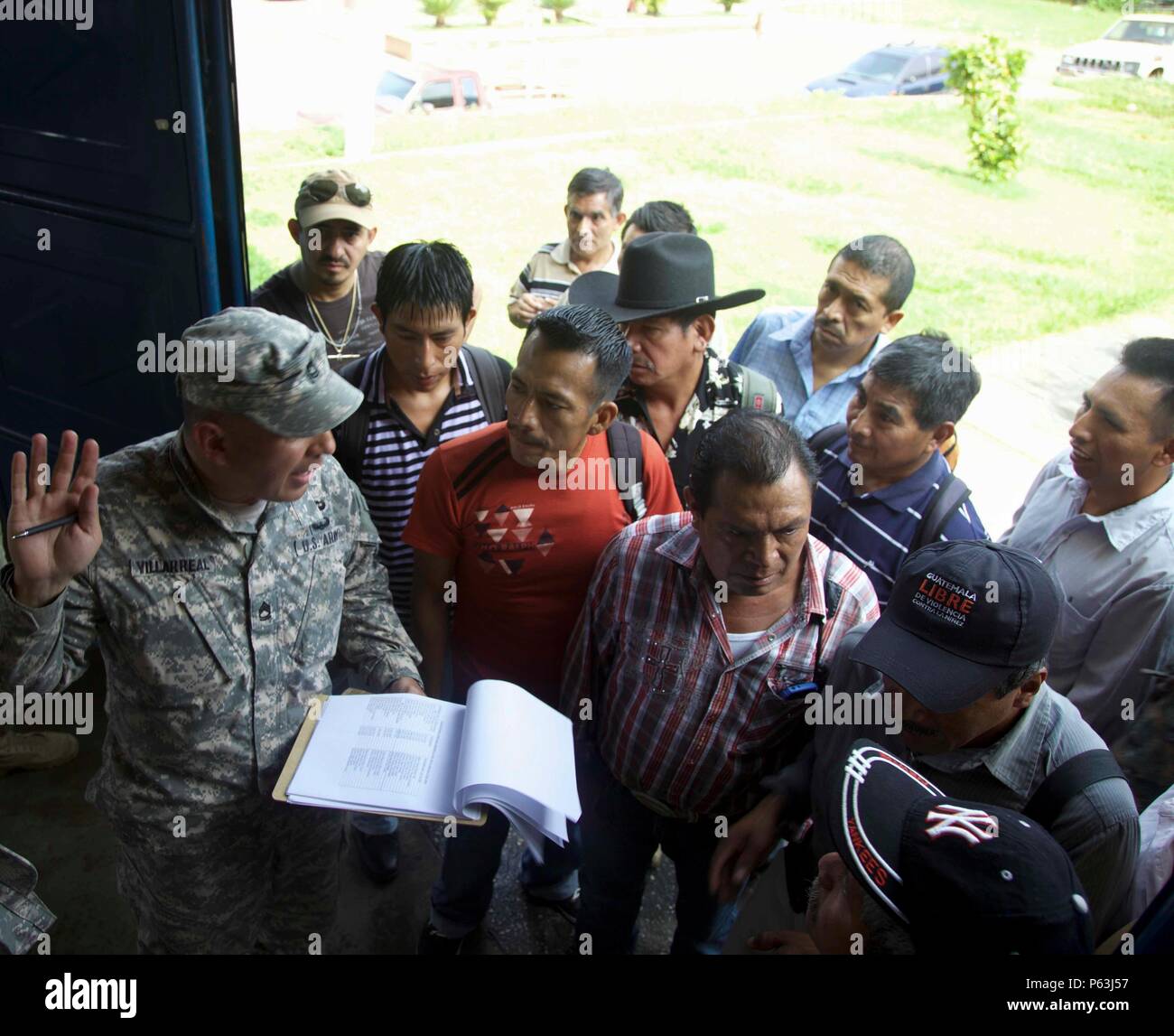 U.S. Army Sgt. 1st Class Luis Villarreal from the 345th Psychological Operations Company has the local Cocodes sign a paper to ensure he knows how many members show up to the Medical Readiness Exercise meeting as part of the Beyond The Horizon Operation at San Pablo, Guatemala, April 29, 2016. Task Force Red Wolf and Army South conducts Humanitarian Civil Assistance Training to include tactical level construction projects and Medical Readiness Training Exercises providing medical access and building schools in Guatemala with the Guatemalan Government and non-government agencies from 05MAR16 to Stock Photo