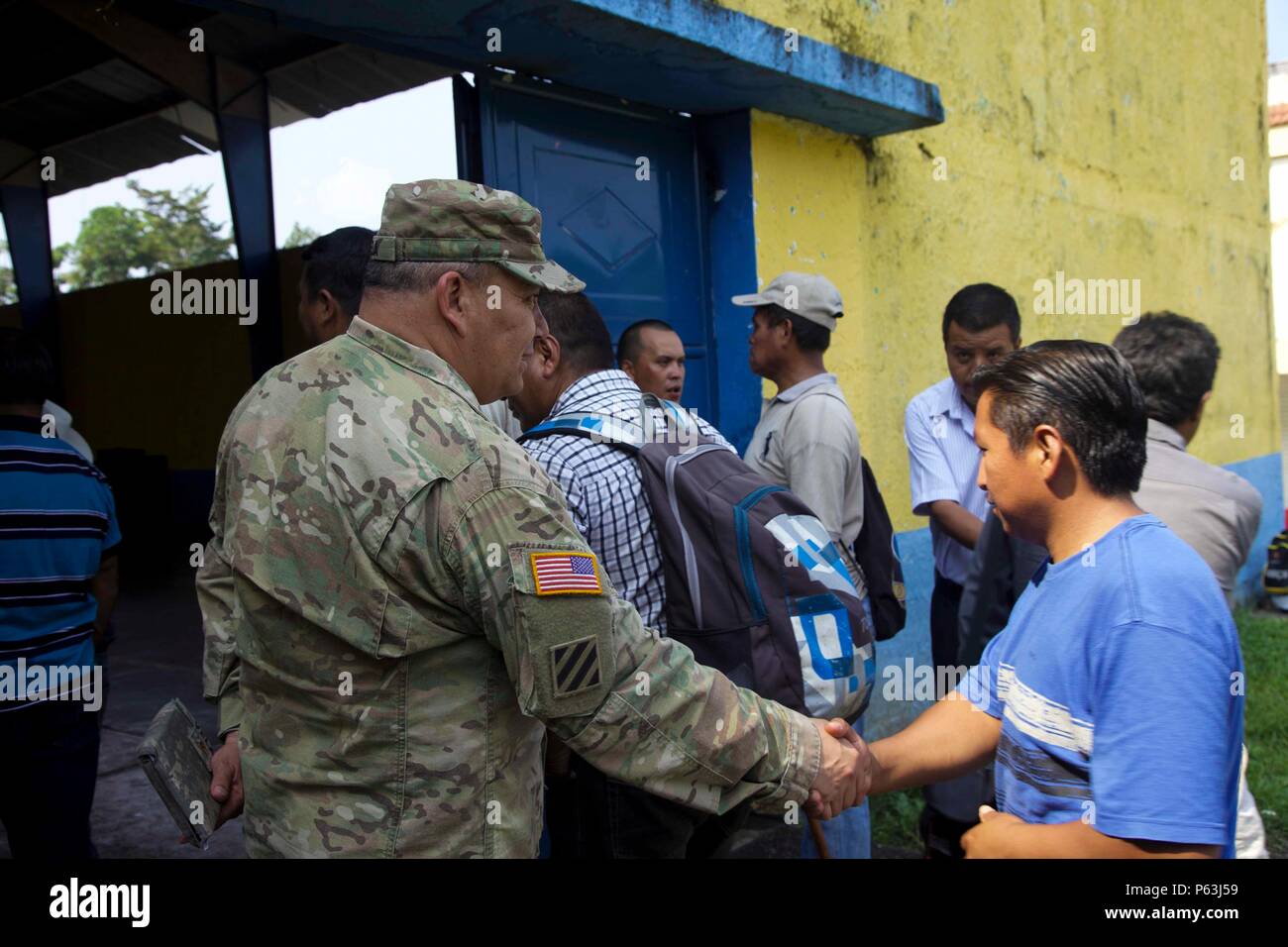 U.S. Army Maj. Edward Vela from the 413th Civil Affairs Battalion greets the local Cocodes to the Medical Readiness Exercise meeting at San Pablo, Guatemala, April 29, 2016. Task Force Red Wolf and Army South conducts Humanitarian Civil Assistance Training to include tactical level construction projects and Medical Readiness Training Exercises providing medical access and building schools in Guatemala with the Guatemalan Government and non-government agencies from 05MAR16 to 18JUN16 in order to improve the mission readiness of US forces and to provide a lasting benefit to the people of Guatema Stock Photo