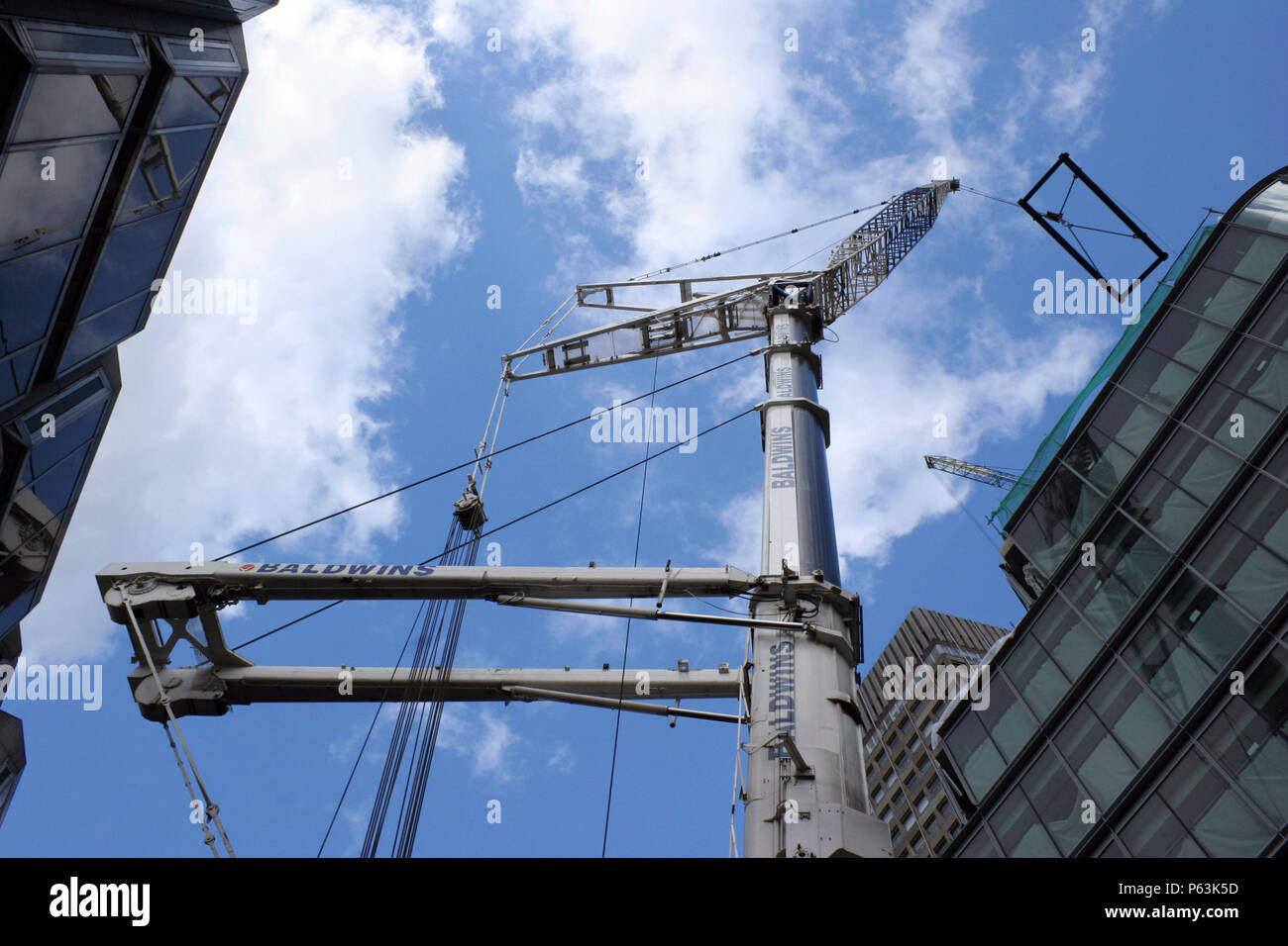 Looking up at the lifting rig of a heavy lift crane from street level