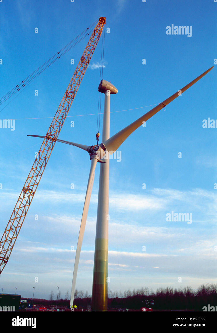 The hub and blades of a large Enercon wind turbine are winched into position at dawn. Worksop. United Kingdom. 2008. Stock Photo
