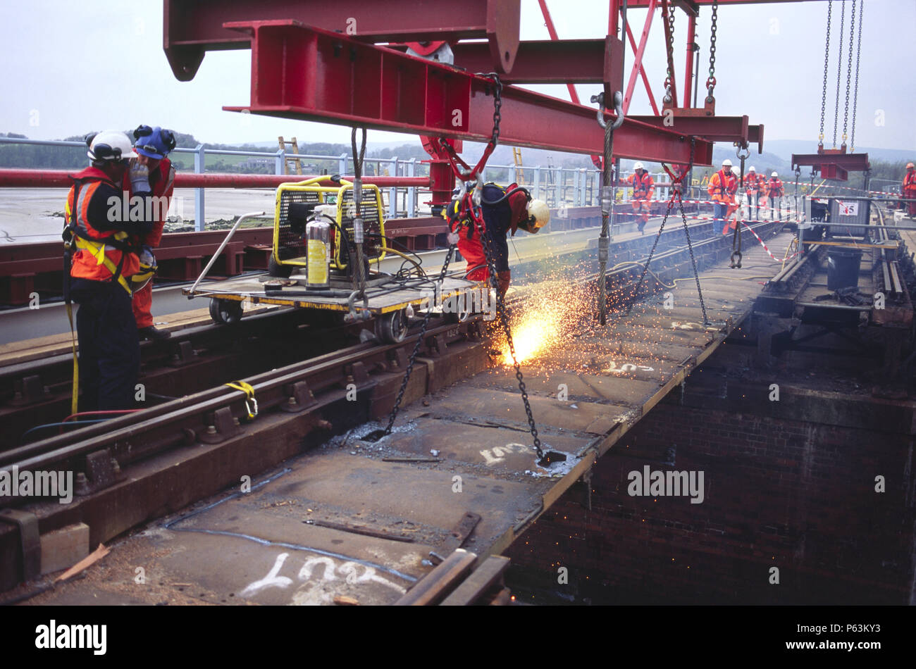 Thermic lance in use to cut out old bridge sections on a railway crossing on the northern coast of Morecombe Bay for an upgrading programme, England,  Stock Photo