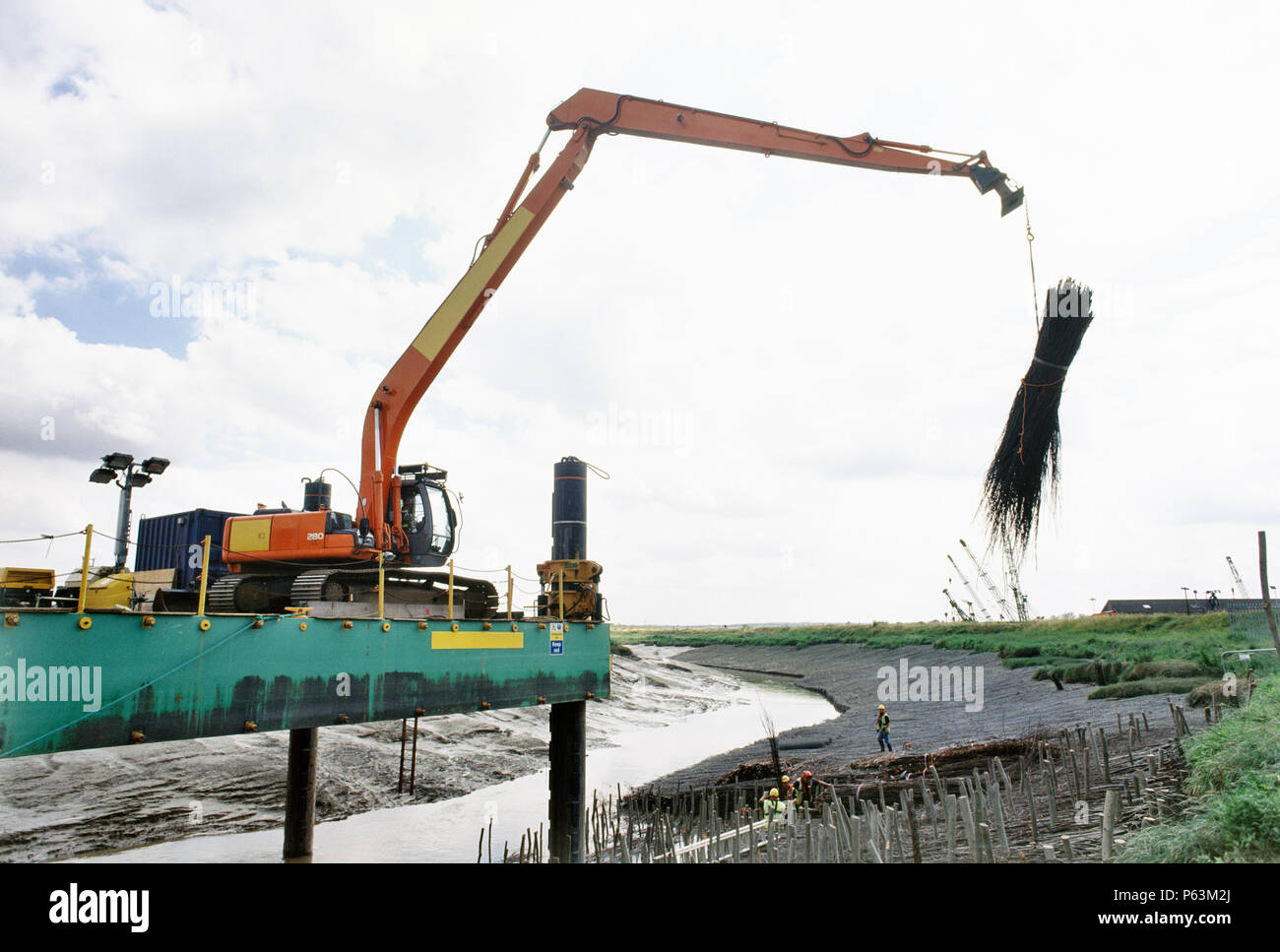Lifting in faggots using the long reach Hitachi excavator on the hack