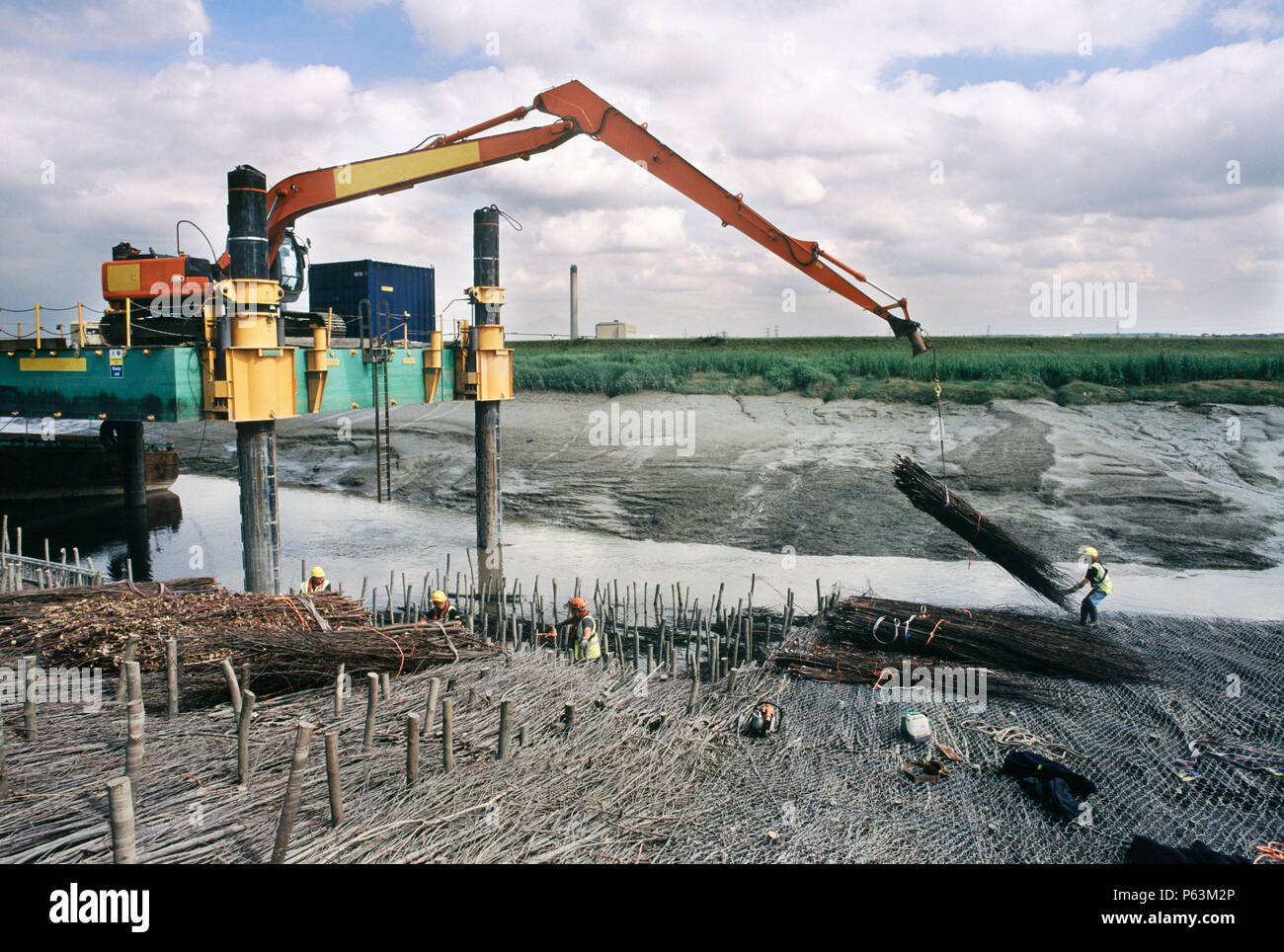 Lifting in faggots using the long reach Hitachi excavator on the jack