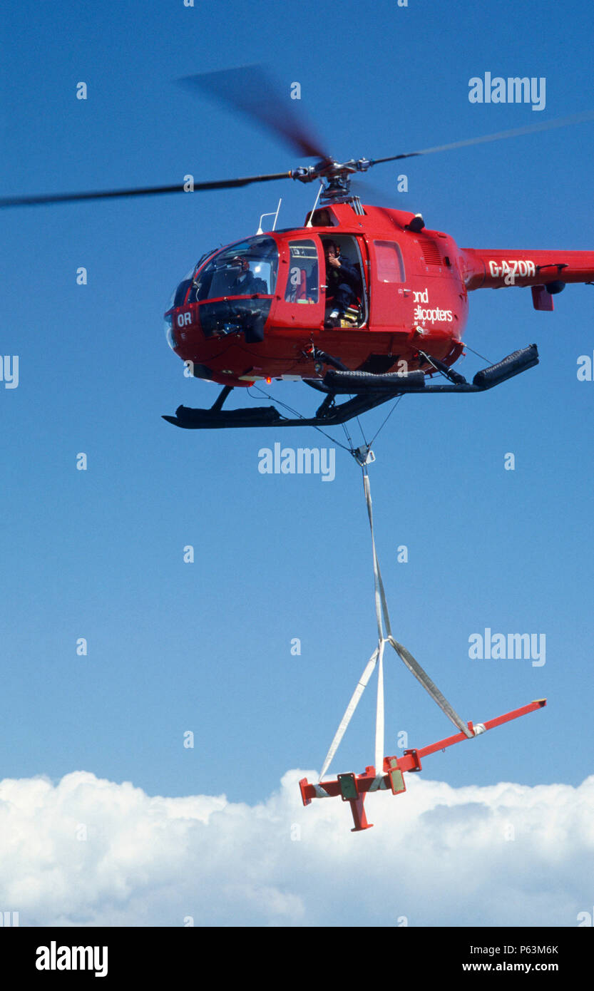 A helicopter delivers steel parts for a helicopter landing platform