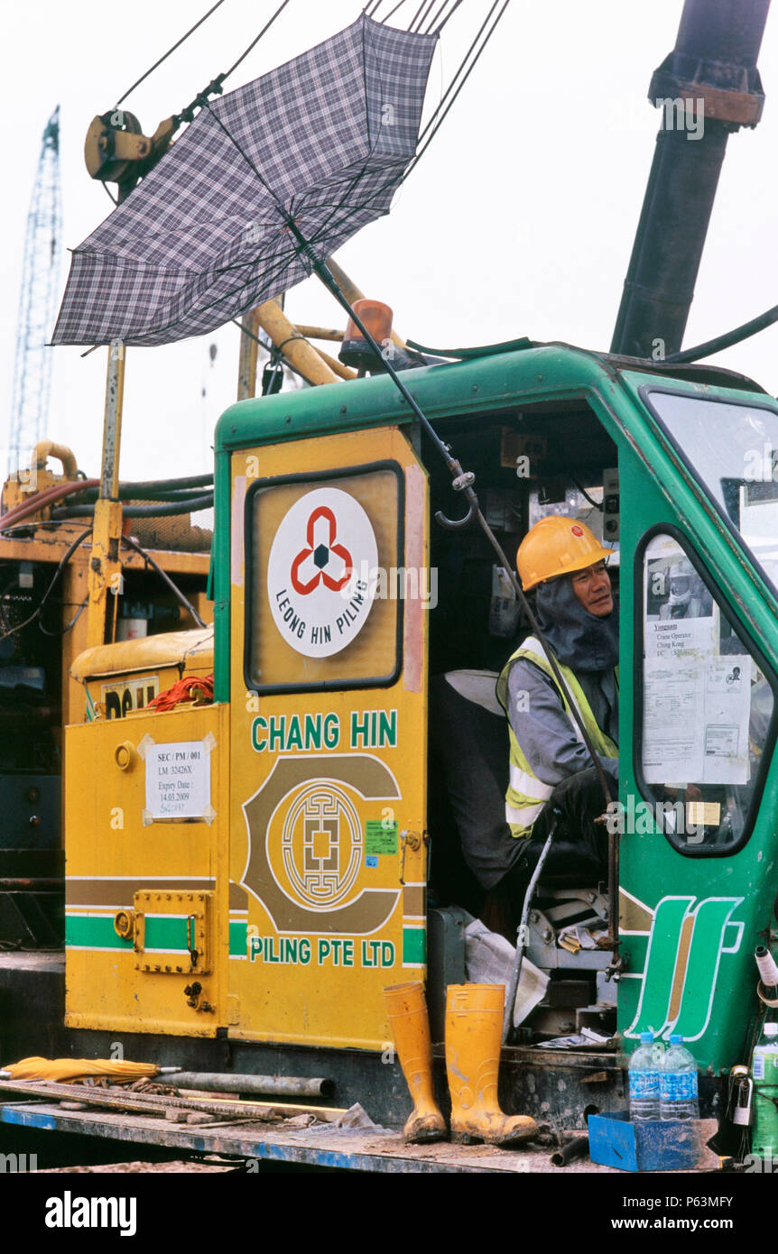 A reversed umbrella for sunshade on a piling rig cab in Singapore Stock Photo