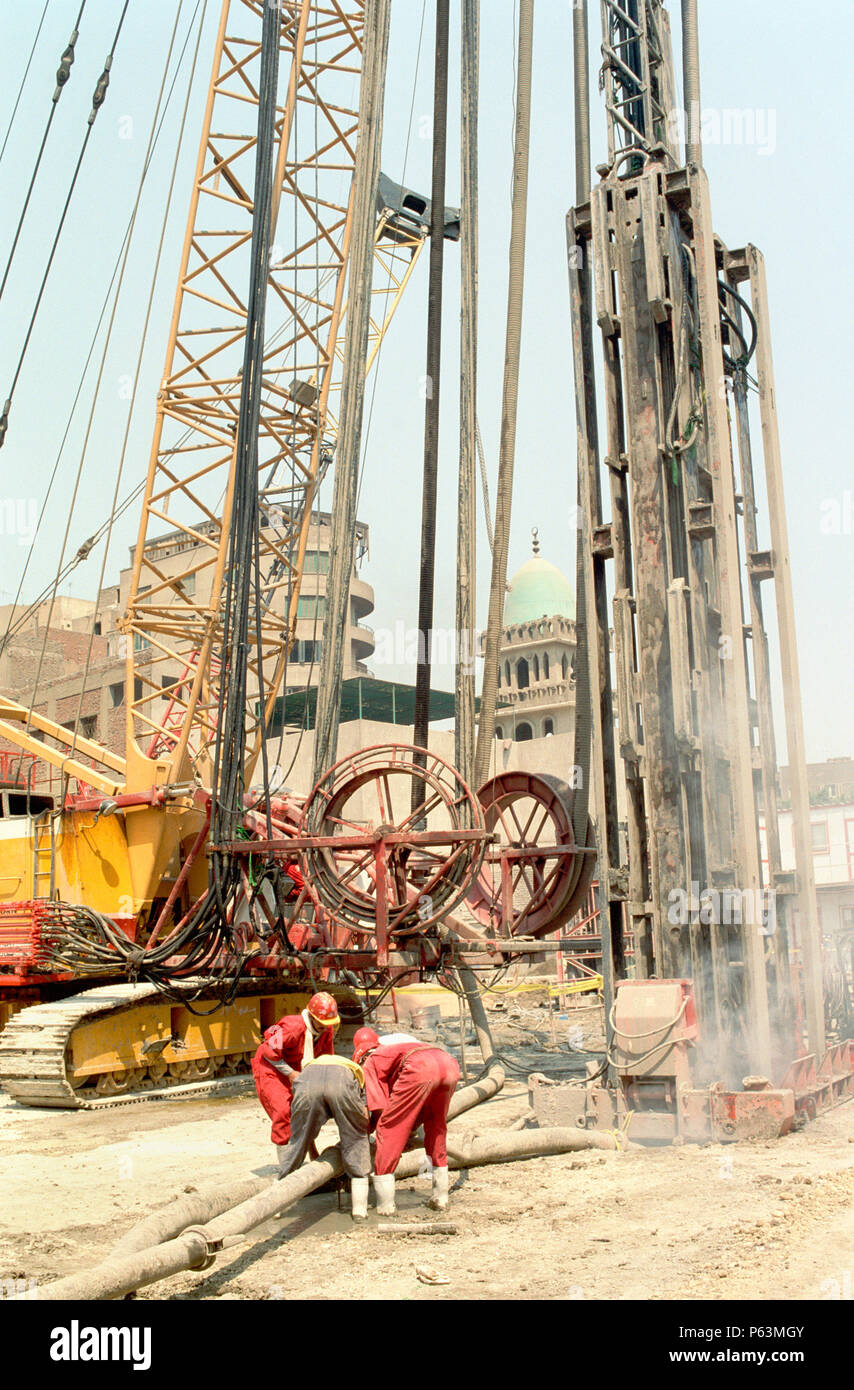 Connectiing the bentonite mud line to a hydrofraise machine which grinds a narrow trench in the rock with spoil removed in a mud flow. the concrete fi Stock Photo