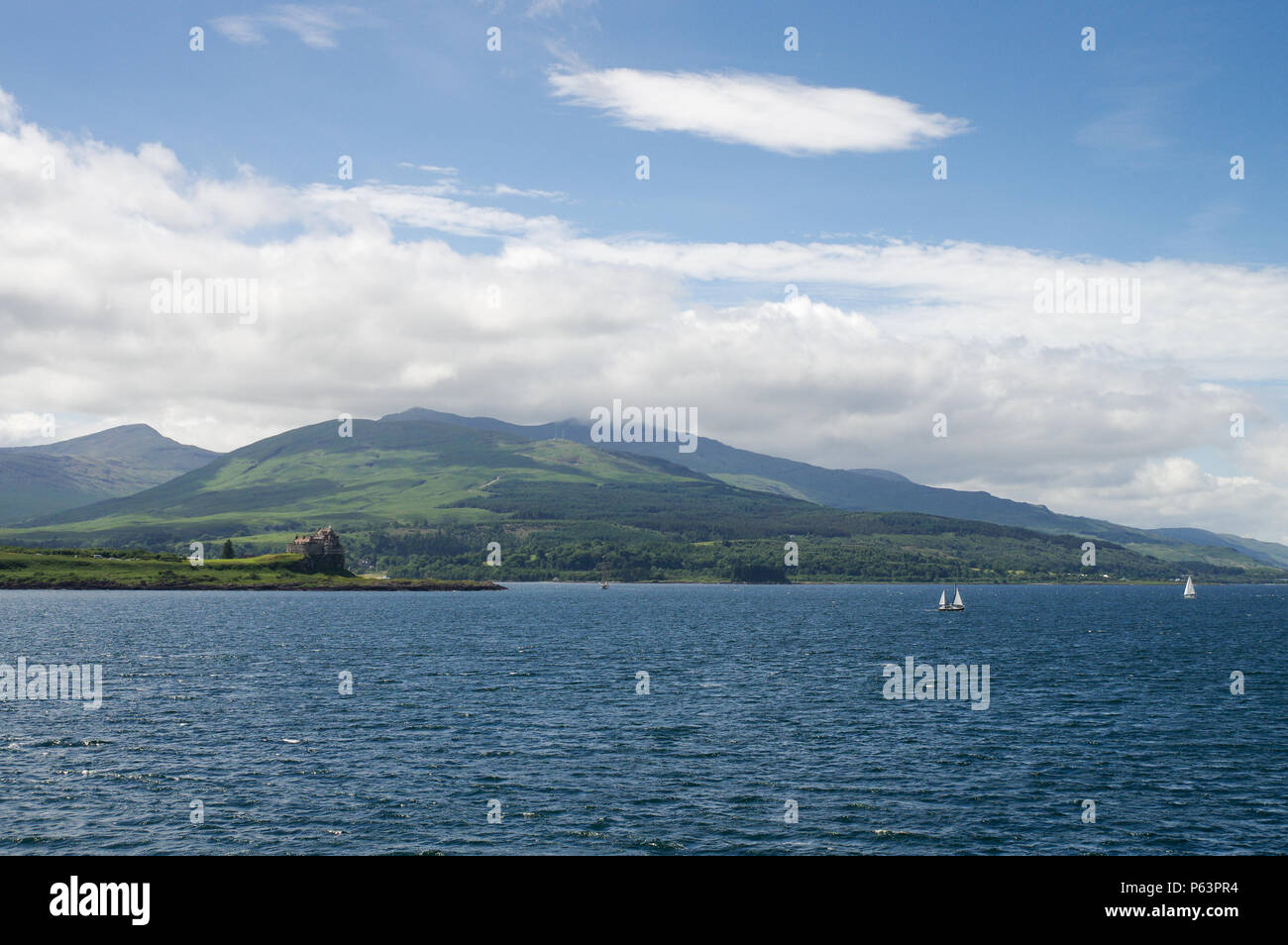 Scenic Isle of Mull seen from the sea, with Duart Castle on the left - Scotland, Great Britain Stock Photo
