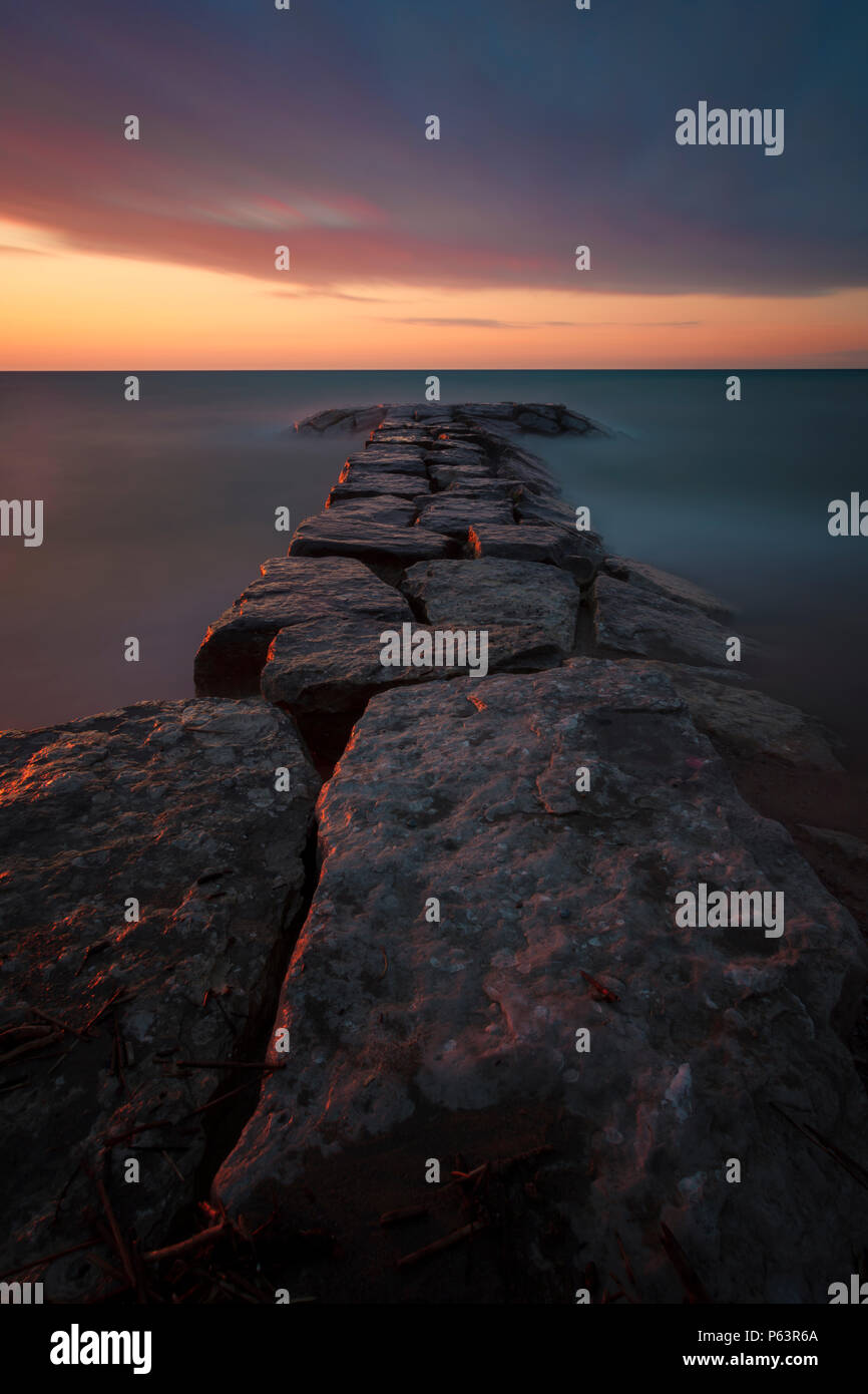 Rock walls of Bright's Grove in Sarnia, Lambton County, Ontario, Canada at sunset in early summer. Stock Photo