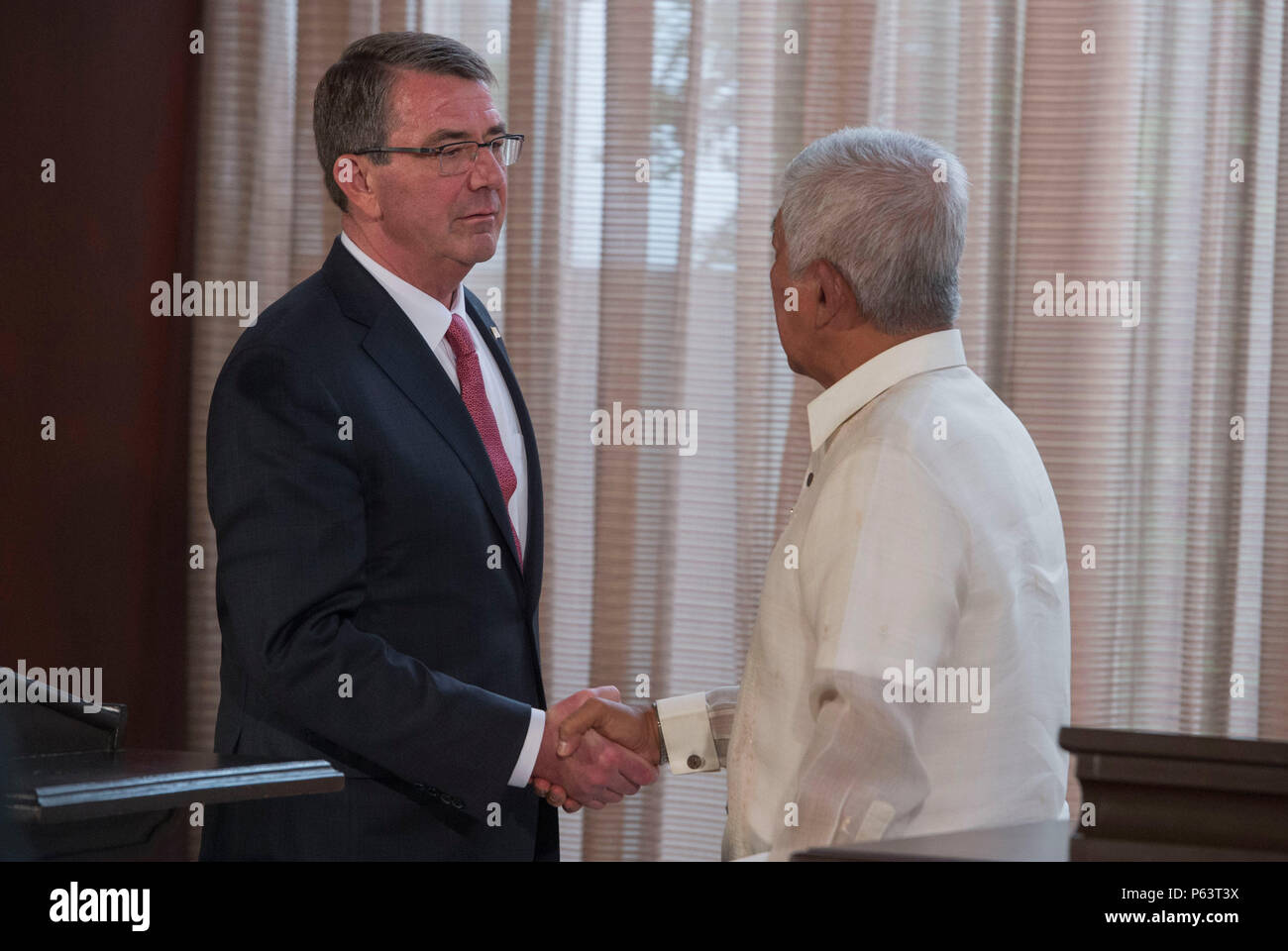 Secretary of Defense Ash Carter and Philippine Secretary of National Defense Voltaire Gazmin shake hands at the conclusion of a joint press conference at the Malacanang Palace in Manila, Philippines April 14, 2016. Carter is visiting the Philippines to solidify the rebalance to the Asia-Pacific region.(Photo by Senior Master Sgt. Adrian Cadiz) Stock Photo
