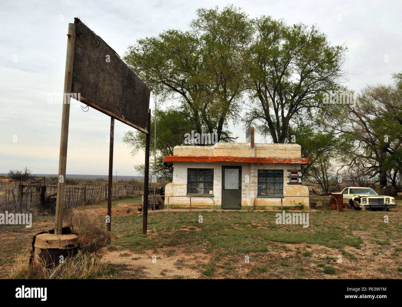 An abandoned car sits beside the closed Little Juarez Cafe in the Route 66 ghost town of Glenrio, which sits on the Texas - New Mexico state line. Stock Photo