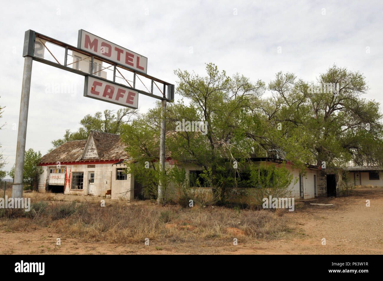 Trees overtake the abandoned Texas Longhorn Motel and State Line Cafe in the Route 66 ghost town of Glenrio on the Texas-New Mexico border. Stock Photo