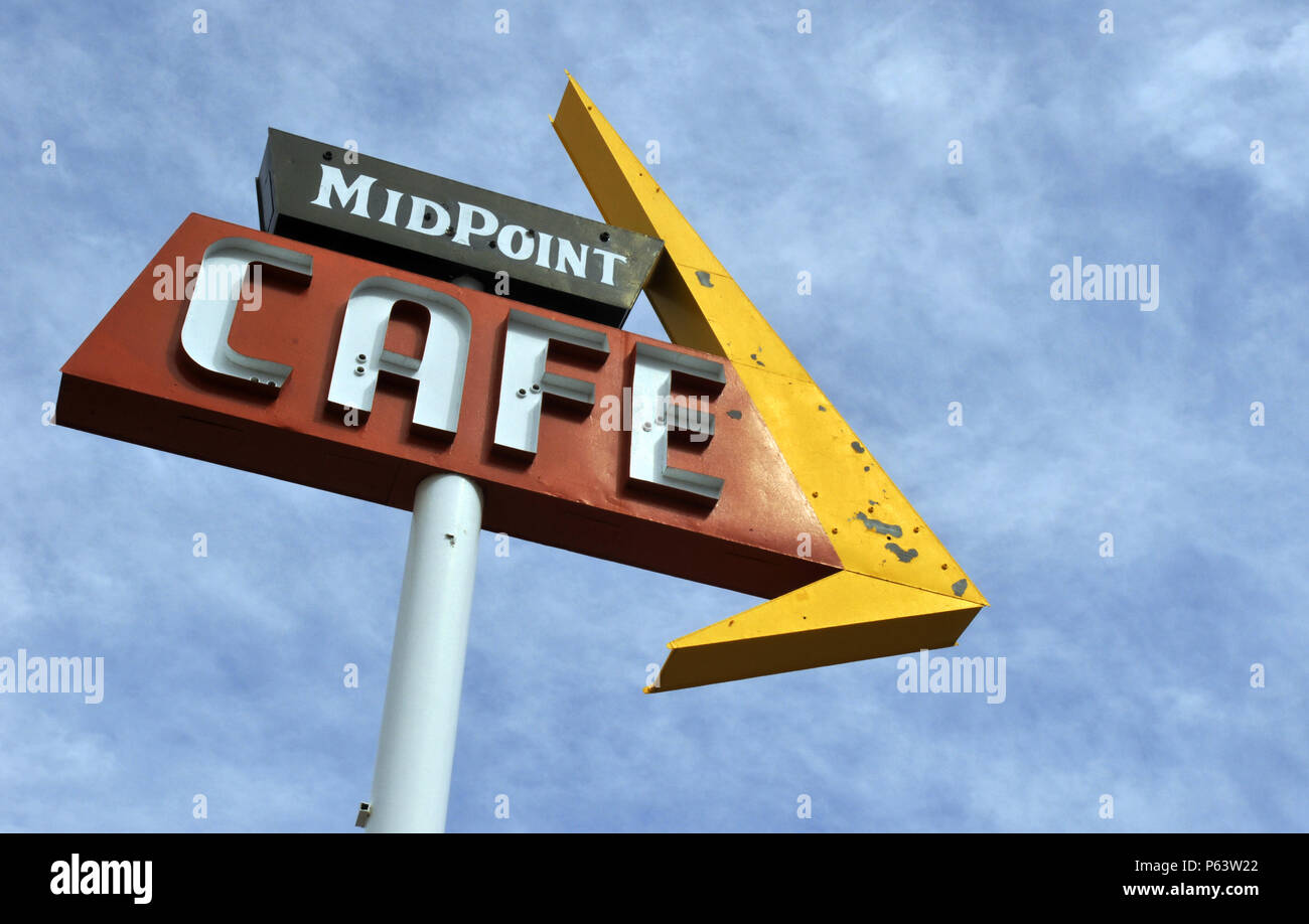A sign advertising the Midpoint Cafe stands along Route 66 in Adrian, Texas, marking the halfway point of the legendary American road. Stock Photo