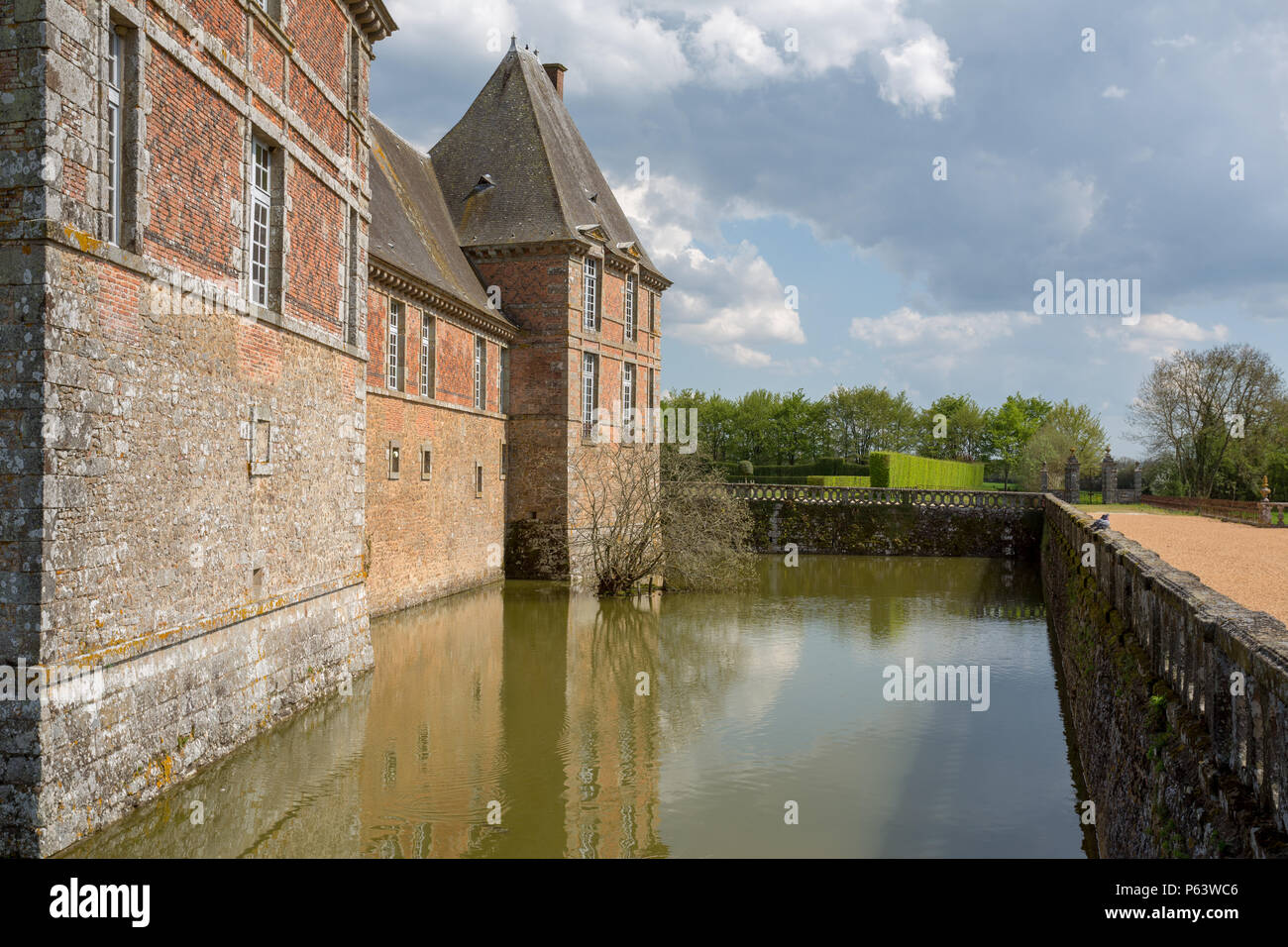 The moat surrounding Chateau de Carrouges. Stock Photo