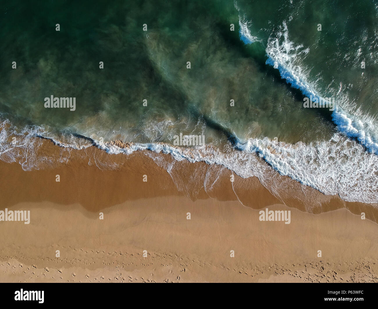 An aerial shot at 330 feet/100 meters looking down at the Pacific Ocean  breaking along the Southern California Coast. Strong waves and currents  leave Stock Photo - Alamy