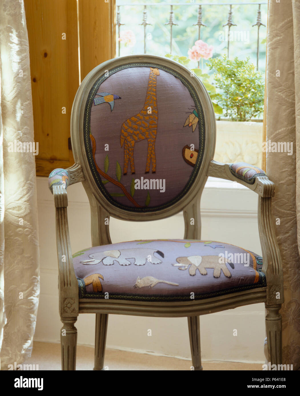 Close up of dining chair upholstered with mauve wild animal