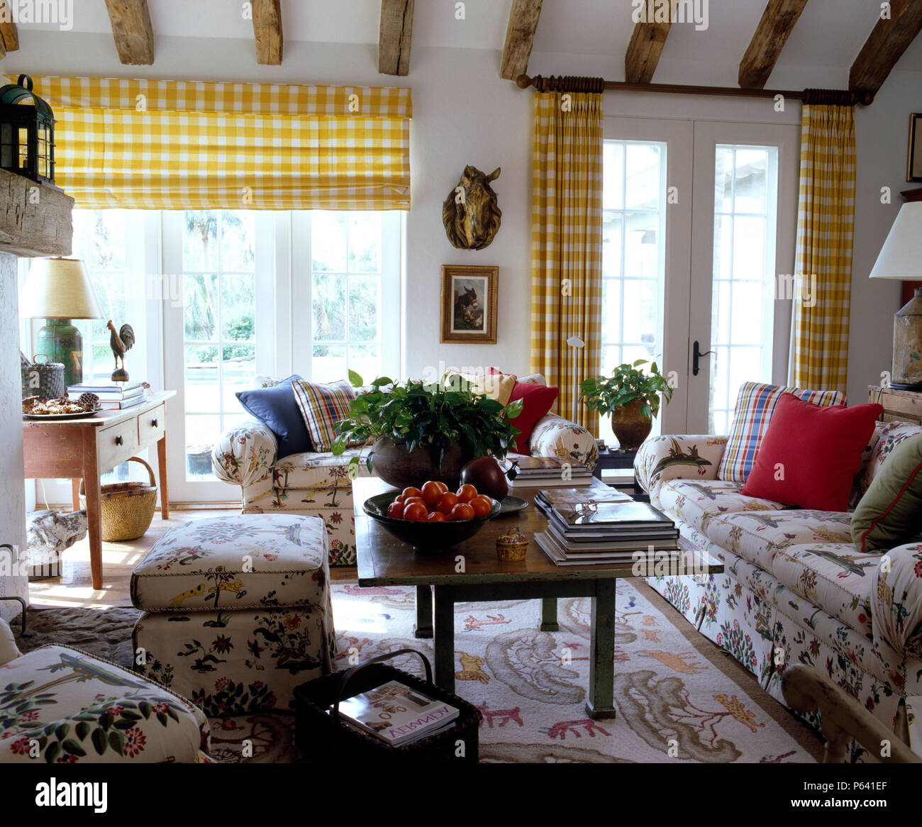 Yellow Checked Blind And Curtains On French Windows In A Sunny Country Living Room With Floral Sofas And Ottoman Stock Photo Alamy