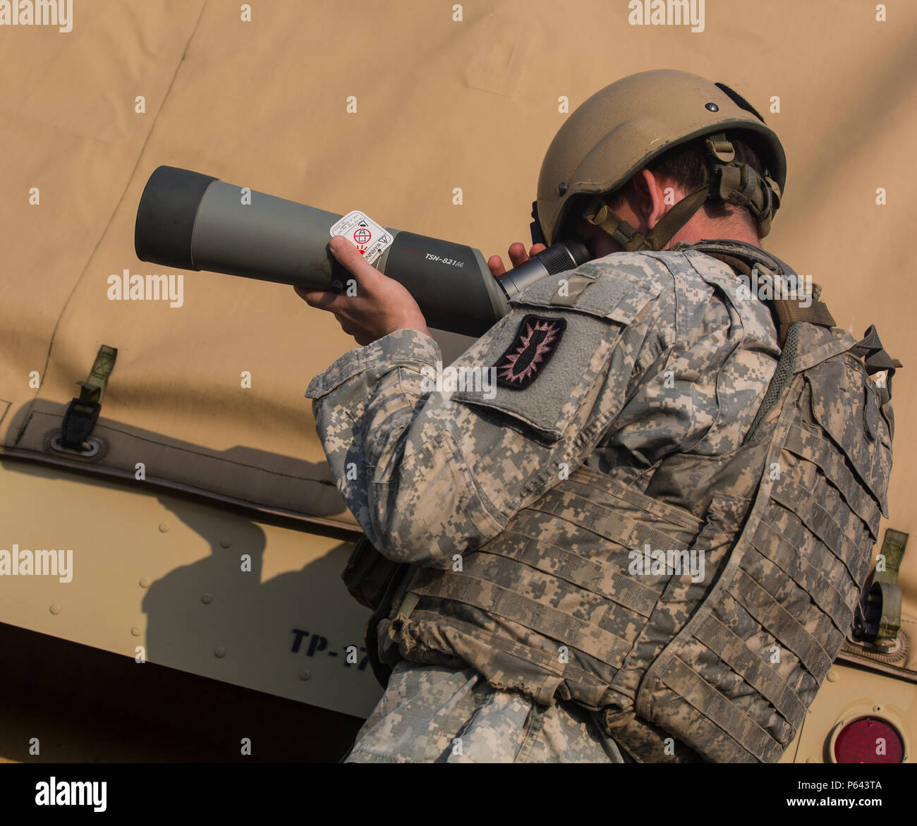 U.S. Army Staff Sgt. Jesse Harris assigned to the 49th Ordnance Company (EOD), 184th Ordnance Battalion (EOD), looks through a spotting scope during the 52nd  Ordnance Group (EOD) Team of the Year 2016 competition at Wendell H. Ford Regional Training Center, Greenville, Ky., April 27, 2016. The weeklong competition test teams, consisting of (2 to 3) EOD Technicians, in various scenarios they may encounter in situations around the world, to determine the most physically, mentally, tactically, and technically fit team to represent their command in future competition. (U.S. Army Photo by Pfc. Aar Stock Photo