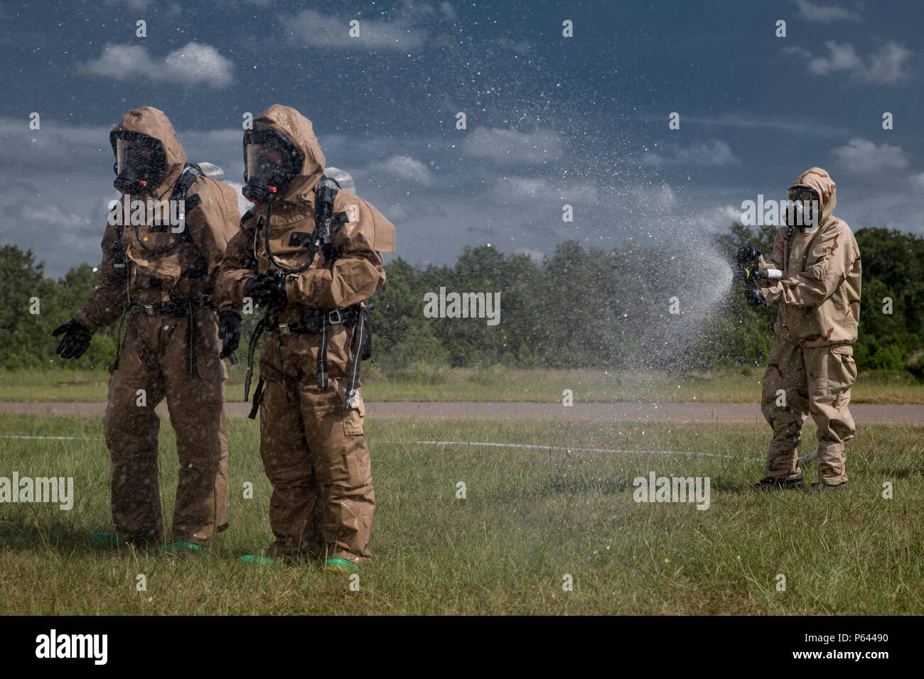 U.S. Marines with Chemical, Biological, Radiological, and Nuclear (CBRN) Platoon, Headquarters Battalion, 1st Marine Division, are sprayed down decontamination during the Concept of Real World CBRN Operations course at the Guardian Centers in Perry, Georgia, June 22, 2018. This training was conducted to enhance and refine the conduct of sensitive site exploitation, which supports the commander’s decision making cycle and maintains momentum during combat operations. (U.S. Marine Corps photo by Cpl. Joseph Prado) Stock Photo