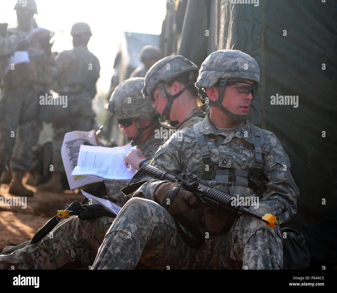 Pfc. Jeffrey P. Doucet (right), 65th Medical Brigade, waits to begin