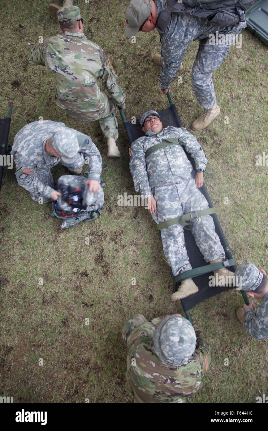 U.S. Army 1st Sgt. Chris Castelleja from the 413th Civil Affairs Battalion gets lifted by U.S. Army Soldiers to be transported to a simulated Medical Operations Area during a Mass Casualty Exercise as part of the Beyond The Horizon Operation at San Marcos, Guatemala, April 26, 2016. Task Force Red Wolf and Army South conducts Humanitarian Civil Assistance Training to include tactical level construction projects and Medical Readiness Training Exercises providing medical access and building schools in Guatemala with the Guatemalan Government and non-government agencies from 05MAR16 to 18JUN16 in Stock Photo
