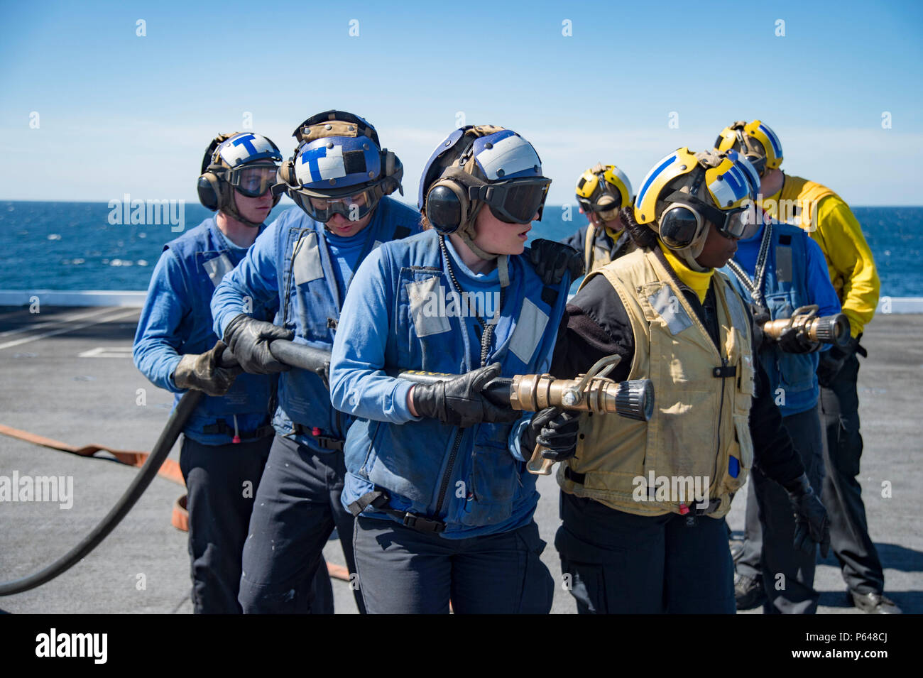 160420-N-KK394-069    ATLANTIC OCEAN (April 20, 2016) - Sailors combat a simulated fire during a fire drill on the flight deck of the aircraft carrier USS Dwight D. Eisenhower (CVN 69), the flagship of the Eisenhower Carrier Strike Group. Ike is underway preparing for an upcoming scheduled deployment. (U.S. Navy photo by Mass Communication Specialist 3rd Class Anderson W. Branch/Released) Stock Photo