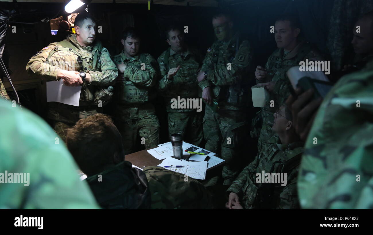 U.S. Soldiers of 3rd Battalion, 227th Aviation Regiment, 1st Air Cavalry Brigade and 173rd Airborne Brigade conduct an air mission brief during exercise Saber Junction 16 at the U.S. Army’s Joint Multinational Readiness Center (JMRC) in Hohenfels, Germany, April 17, 2016. Saber Junction 16 is the U.S. Army Europe’s 173rd Airborne Brigade’s combat training center certification exercise, taking place at the JMRC in Hohenfels, Germany, Mar. 31-Apr. 24, 2016.  The exercise is designed to evaluate the readiness of the Army’s Europe-based combat brigades to conduct unified land operations and promot Stock Photo
