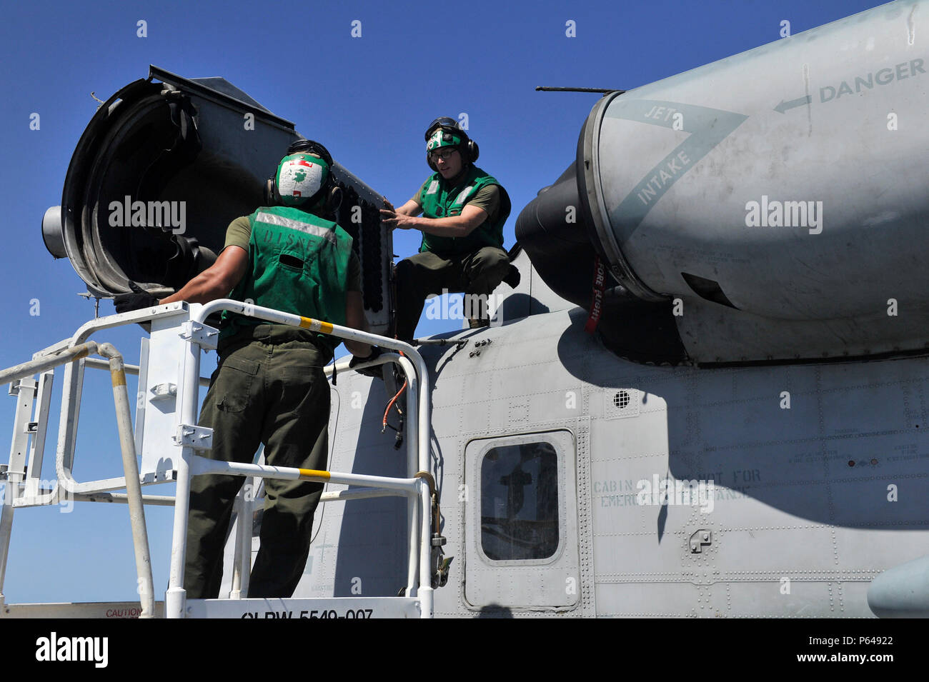 Marines remove the intake cover from the T64-GE-416/416A engines of a ...