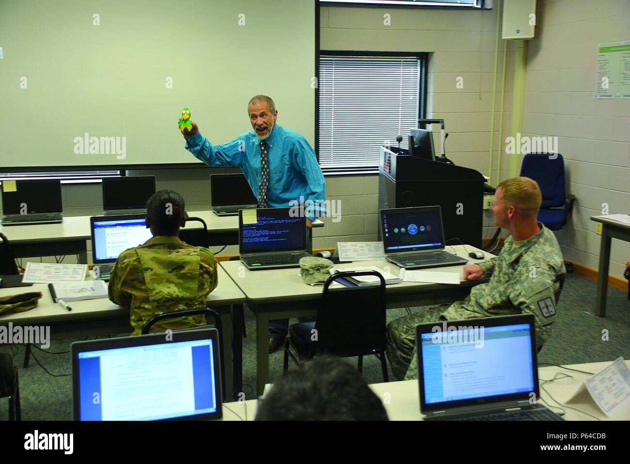 Keith Ferguson, a staff and faculty instructor at the Army Logistics University, attempts to entertain his class while acting like a clown with his Mr. Squeakers prop to introduce them to the design concept of their Systems Approach to Training class. (Photo by Amy Perry, Fort Lee Public Affairs) Stock Photo