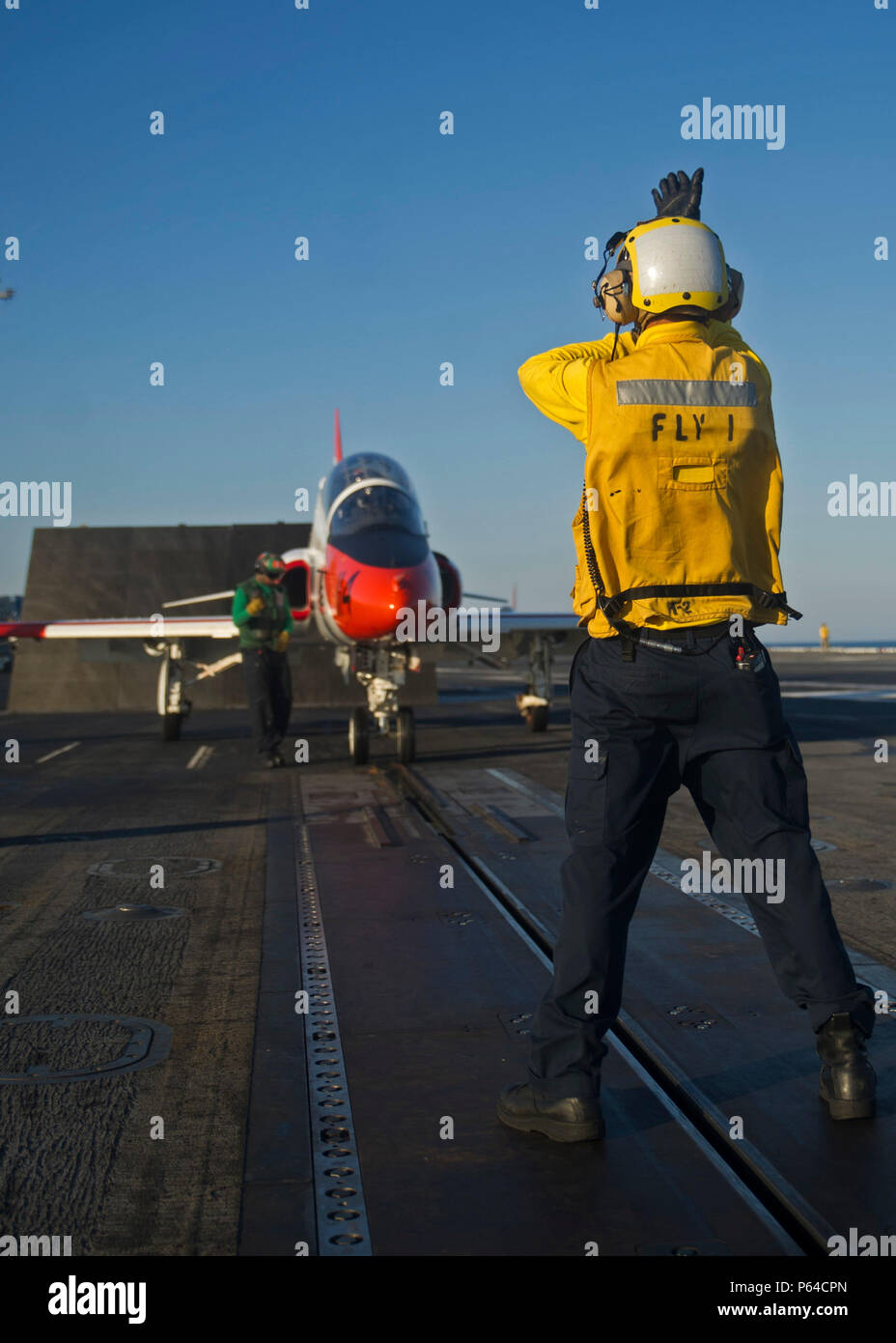 160424-N-VH385-039 ATLANTIC OCEAN (April 24, 2016) An aviation boatswain’s mate (handling) directs a T-45C Goshawk from Training Air Wing 2 onto the catapult of the aircraft carrier USS George Washington (CVN 73). Washington, homeported in Norfolk, is underway conducting carrier qualifications in the Atlantic Ocean. (U.S. Navy photo by Mass Communication Specialist 3rd Class Wyatt L. Anthony/Released) Stock Photo