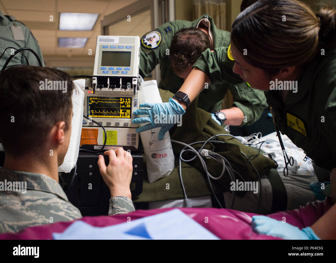 Members of the 59th Medical Wing Extracorporeal Membrane Oxygenation and Critical Care Air Transport Team adjust settings on a vital signs monitor at Lafayette General Medical Center April 20. The teams were preparing the patient for transport to San Antonio Military Medical Center, Joint Base San Antonio-Fort Sam Houston, Texas. Stock Photo