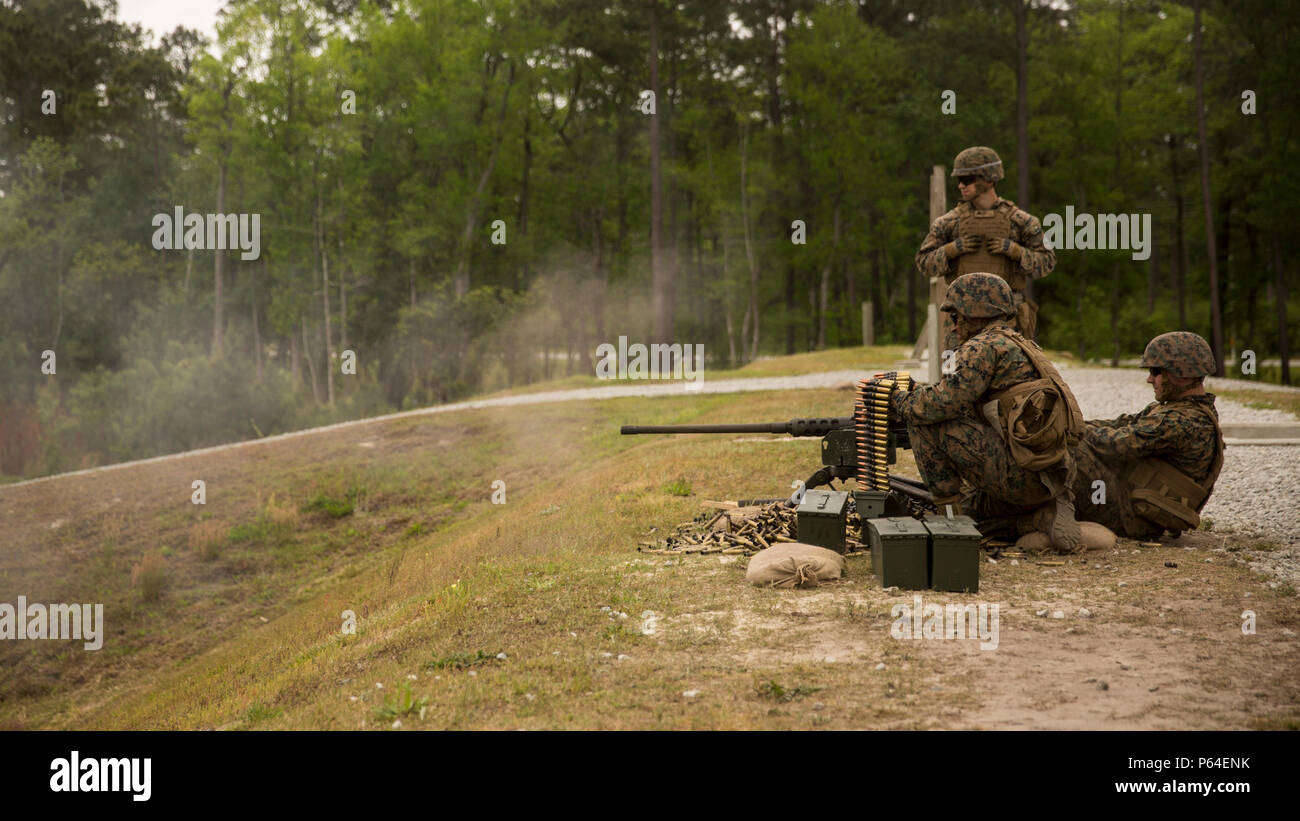 Marines with II Marine Headquarters demonstrate, to visiting family members and spouses, how to operate the .50 Caliber Machine Gun during II MHG’s: “In Their Boots Day” at Camp Lejeune, N.C., April 29, 2016. The Marines also demonstrated a firing method, “talking guns”, using two M240 Bravo Light-Machine Guns and a .50 Caliber Machine Gun. (U.S. Marine Corps photo by Cpl. Justin T. Updegraff/ Released) Stock Photo