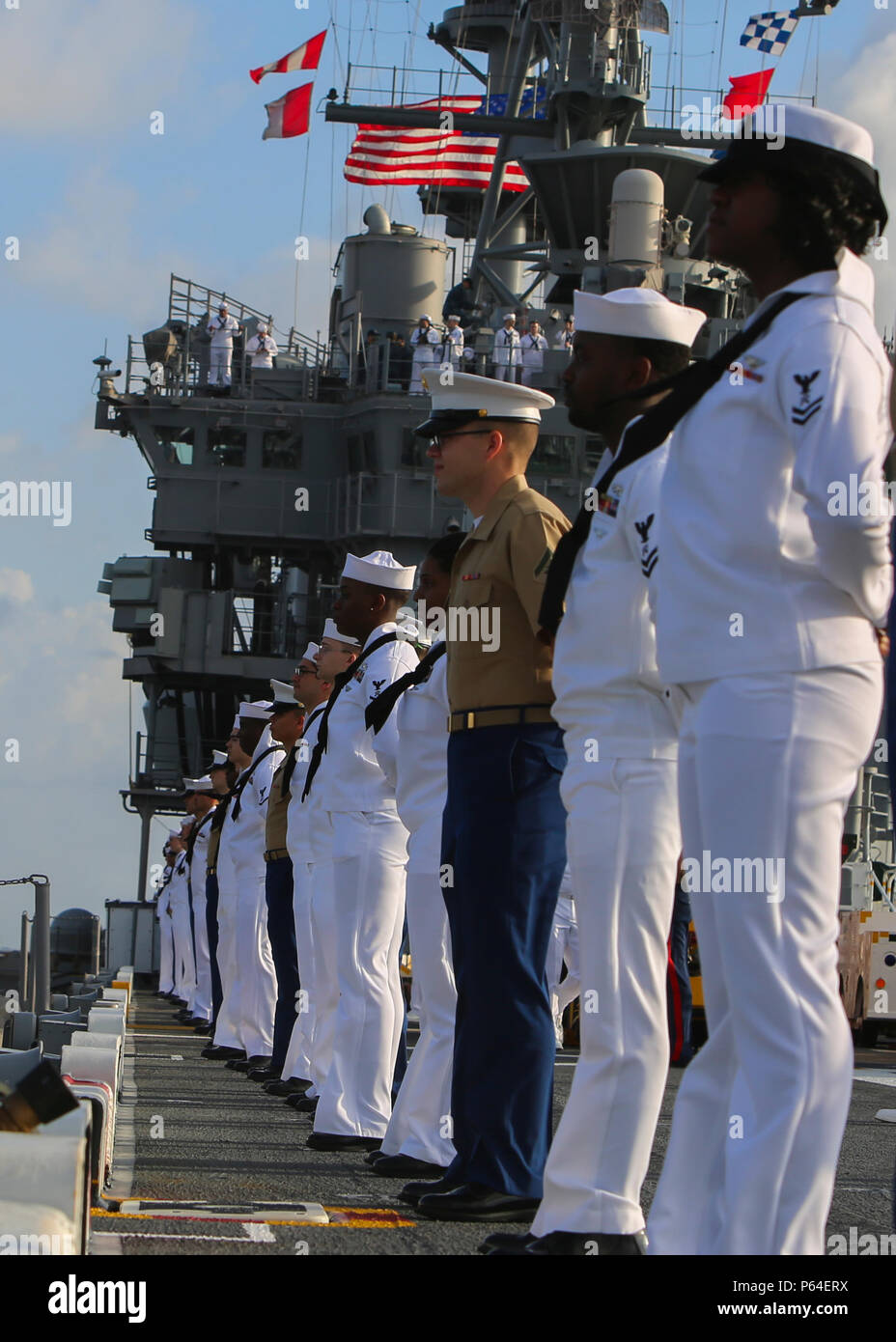 Marines and Sailors man the rails of the USS Bataan as they arrive at Fleet Week Port Everglades, Fla., May 2, 2016. Fleet Week, which takes place in Fort Lauderdale, Fla., from May 2-8, will give the community of South Florida the opportunity to interact with the Marines and Sailors of the ship as well as see up-close and personal some of the capabilities and equipment the Marine Corps employs.  (U.S. Marine Corps photo by Cpl. Michelle Reif/Released.) Stock Photo
