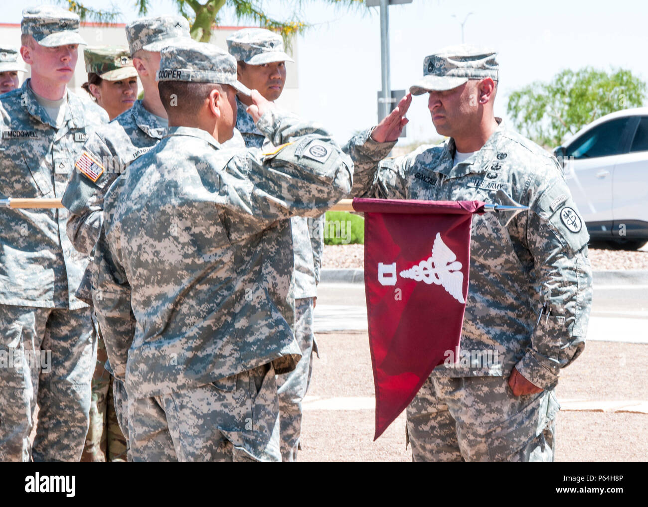 Capt. Michael Cooper (left), commander, D Company, Troop Command, William  Beaumont Army Medical Center, and Sgt. 1st Class Erik Gonzalez (right),  company first sergeant, D Company, salute the D Company colors before