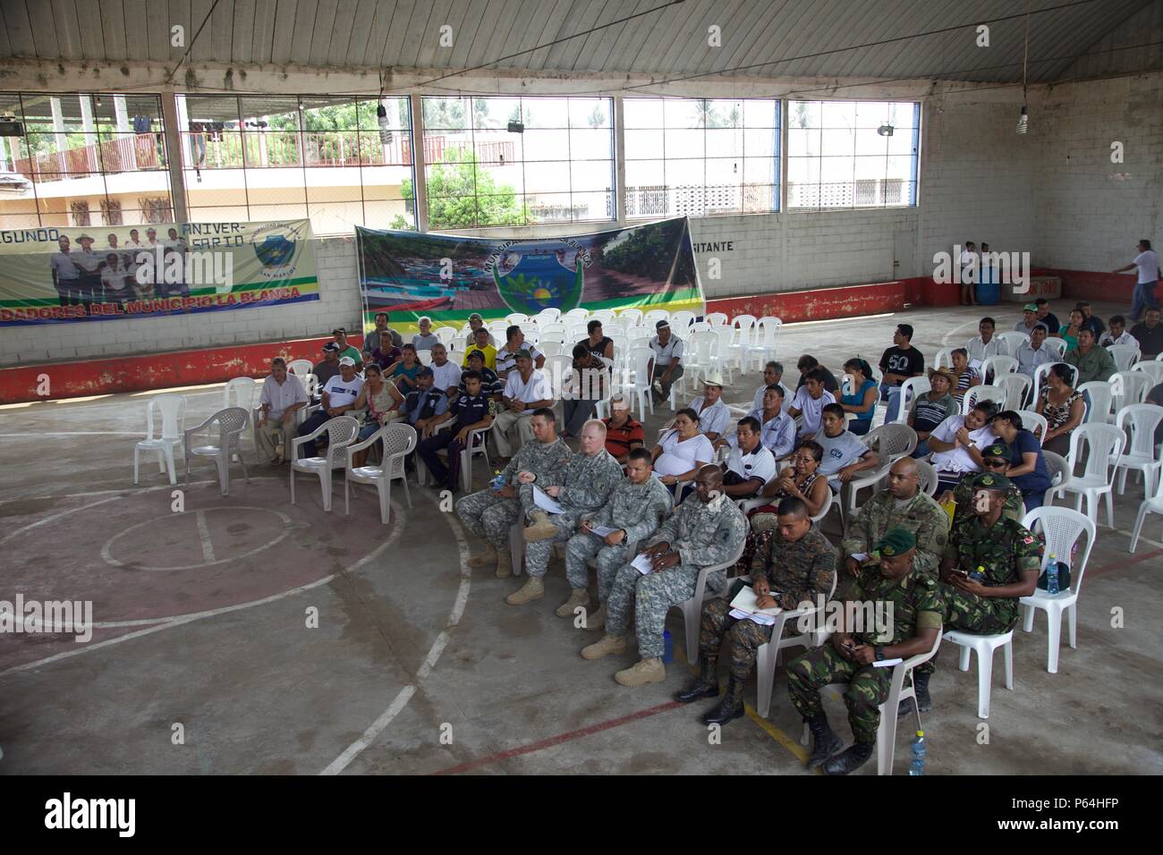 Local Cocodes and Joint Military members assemble to speak to each other about the future Medical Treatment Exercise as part of the Beyond The Horizon Operation at San Pedro, Guatemala, May 04, 2016. Task Force Red Wolf and Army South conducts Humanitarian Civil Assistance Training to include tactical level construction projects and Medical Readiness Training Exercises providing medical access and building schools in Guatemala with the Guatemalan Government and non-government agencies from 05MAR16 to 18JUN16 in order to improve the mission readiness of US forces and to provide a lasting benefi Stock Photo