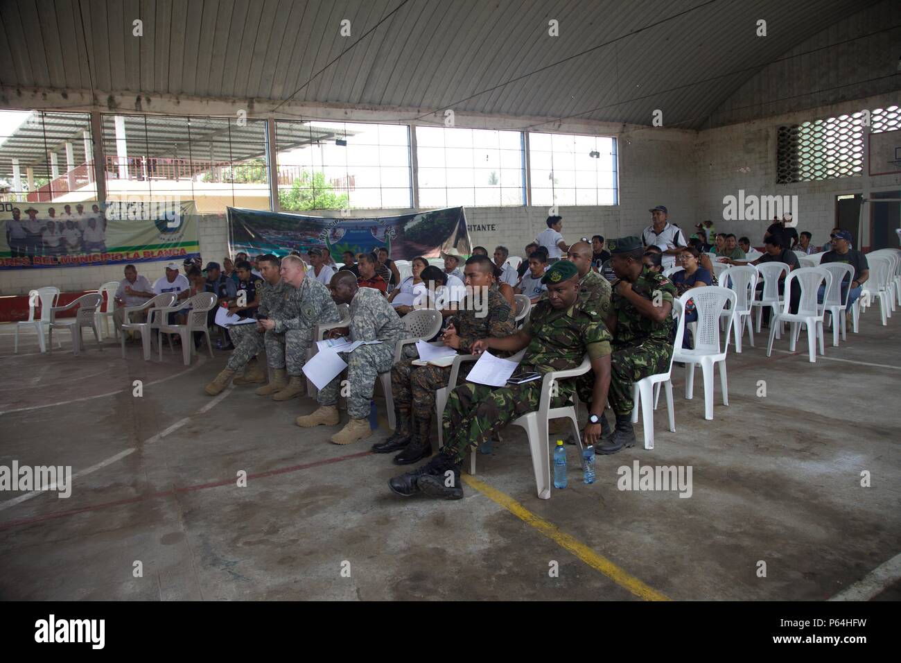 Local Cocodes and Joint Military members assemble to speak to each other about the future Medical Treatment Exercise as part of the Beyond The Horizon Operation at San Pedro, Guatemala, May 04, 2016. Task Force Red Wolf and Army South conducts Humanitarian Civil Assistance Training to include tactical level construction projects and Medical Readiness Training Exercises providing medical access and building schools in Guatemala with the Guatemalan Government and non-government agencies from 05MAR16 to 18JUN16 in order to improve the mission readiness of US forces and to provide a lasting benefi Stock Photo