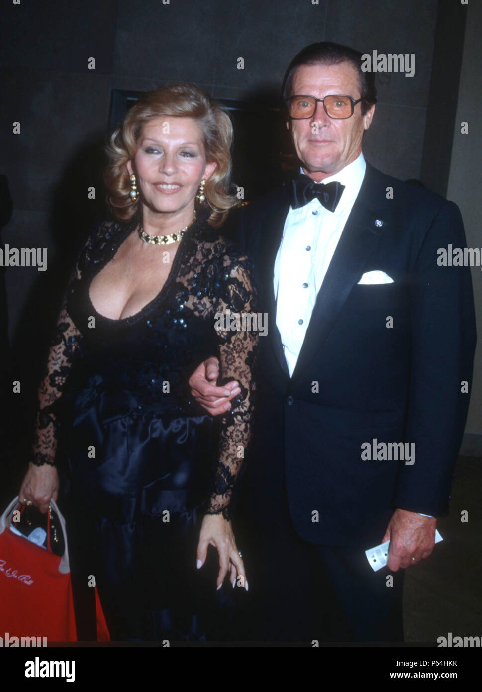 BEVERLY HILLS, CA - DECEMBER 4: (L-R) Luisa Mattioli and actor Roger Moore attend the Second Annual Fire & Ice Ball to Benefit the Revlon/UCLA Women's Cancer Research Program on December 4, 1991 at the Beverly Hilton Hotel in Beverly Hills, California. Photo by Barry King/Alamy Stock Photo Stock Photo