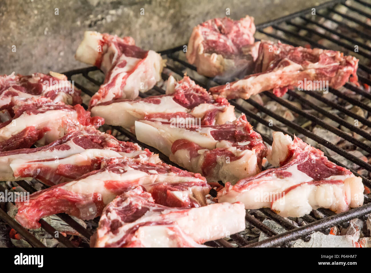 grilled goat chops. Roast meat on a barbecue Typical brick barbecue in Sardinia, Italy. Selective focus Stock Photo