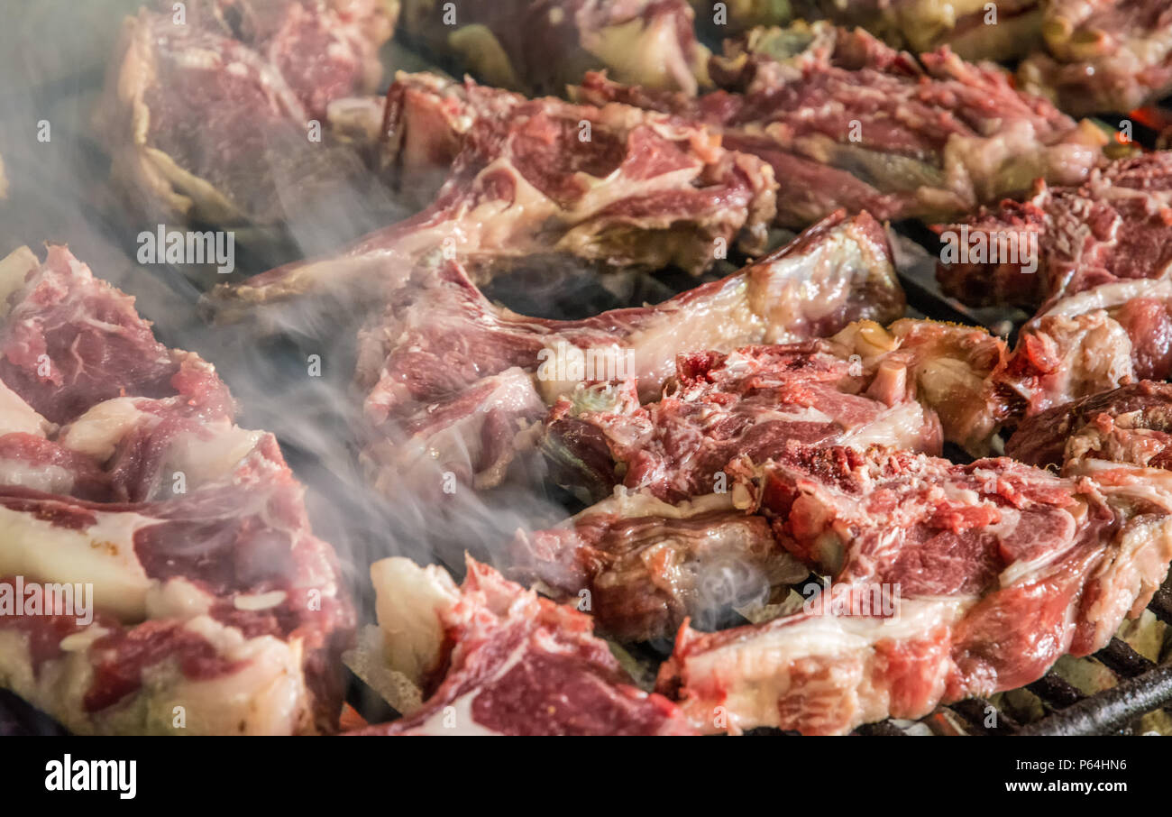 grilled goat chops. Roast meat on a barbecue Typical brick barbecue in Sardinia, Italy. Selective focus Stock Photo