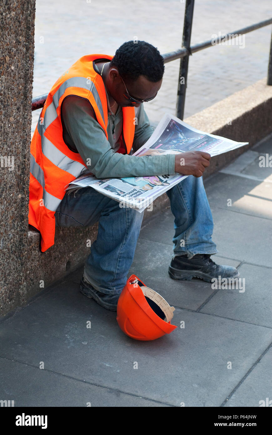 Construction site worker having a break, London, UK Stock Photo